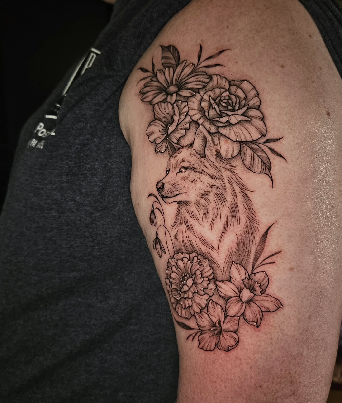 Wolf and flowers realism tattoo on the shoulder by Courtlyn Bliss