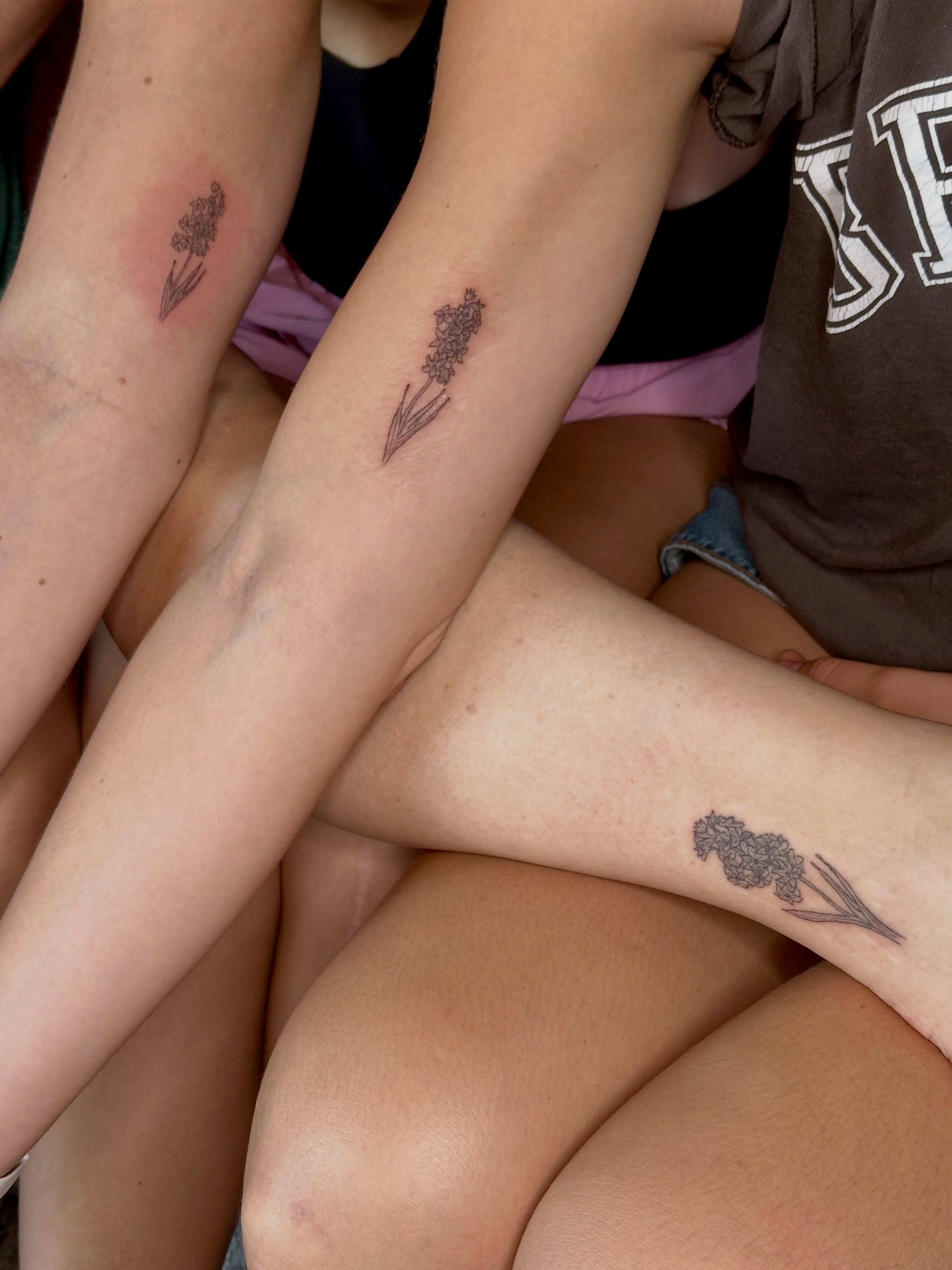 Lavender black and grey tattoo on the forearm by Liz