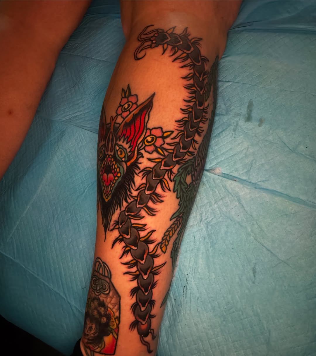 Serpent and flowers American traditional tattoo on the forearm by Arron Albaugh
