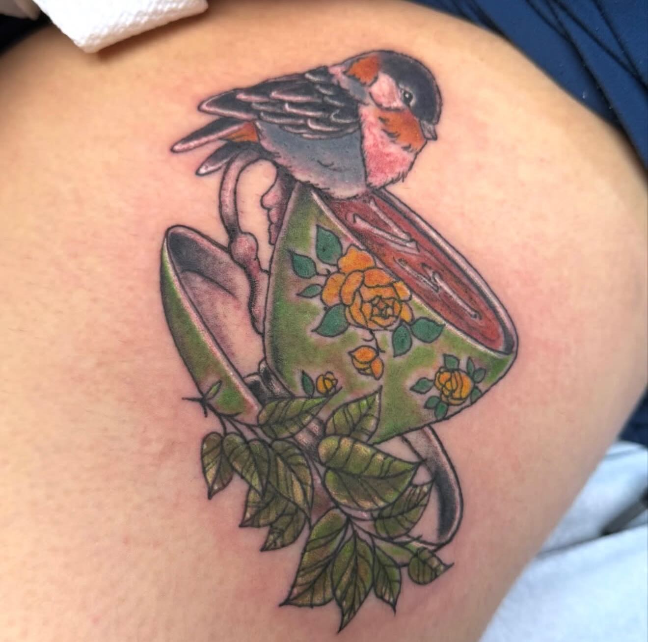 Bird and teacup American traditional tattoo on the thigh by Tattoos By Trish