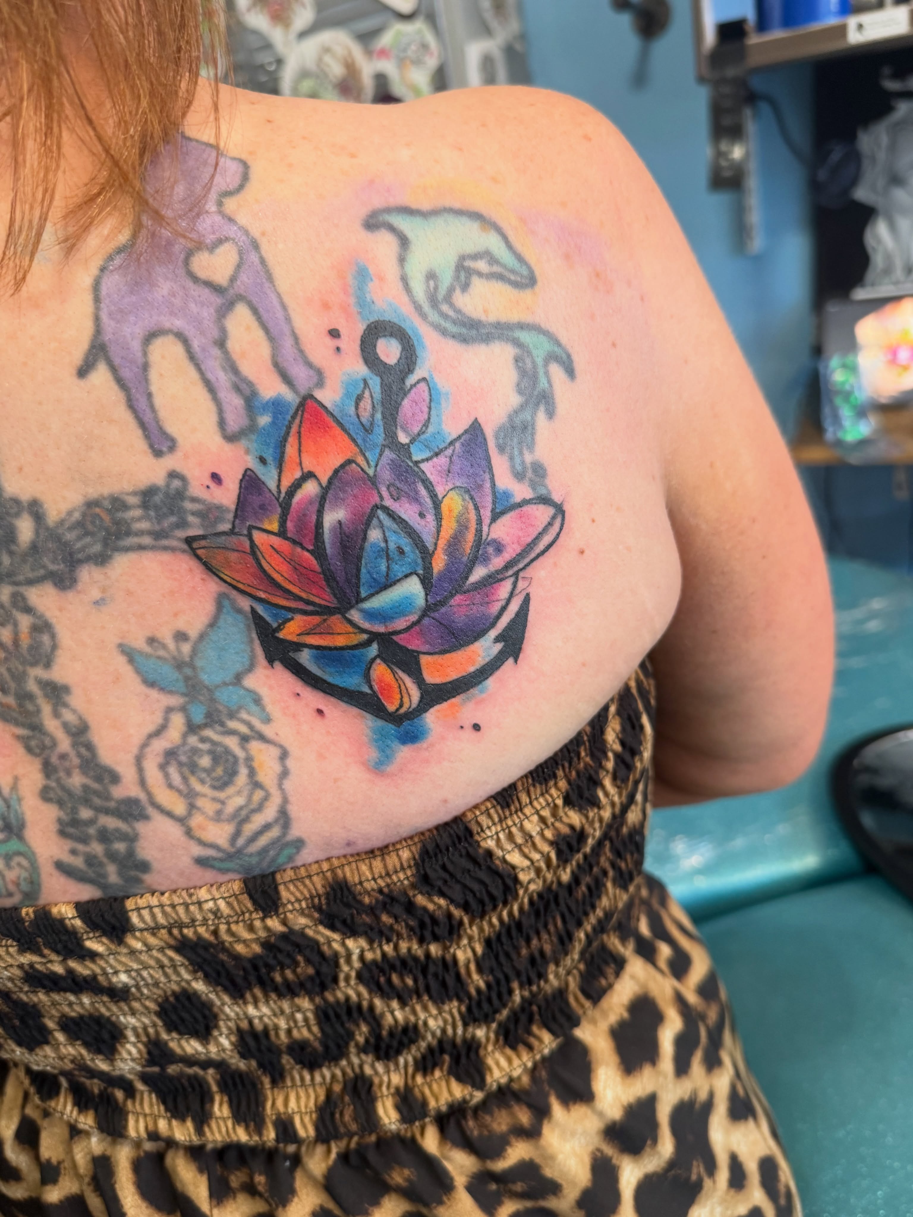 Lotus flower and anchor watercolor tattoo on the back by Misty Dawn Brothers, Dayton, Ohio