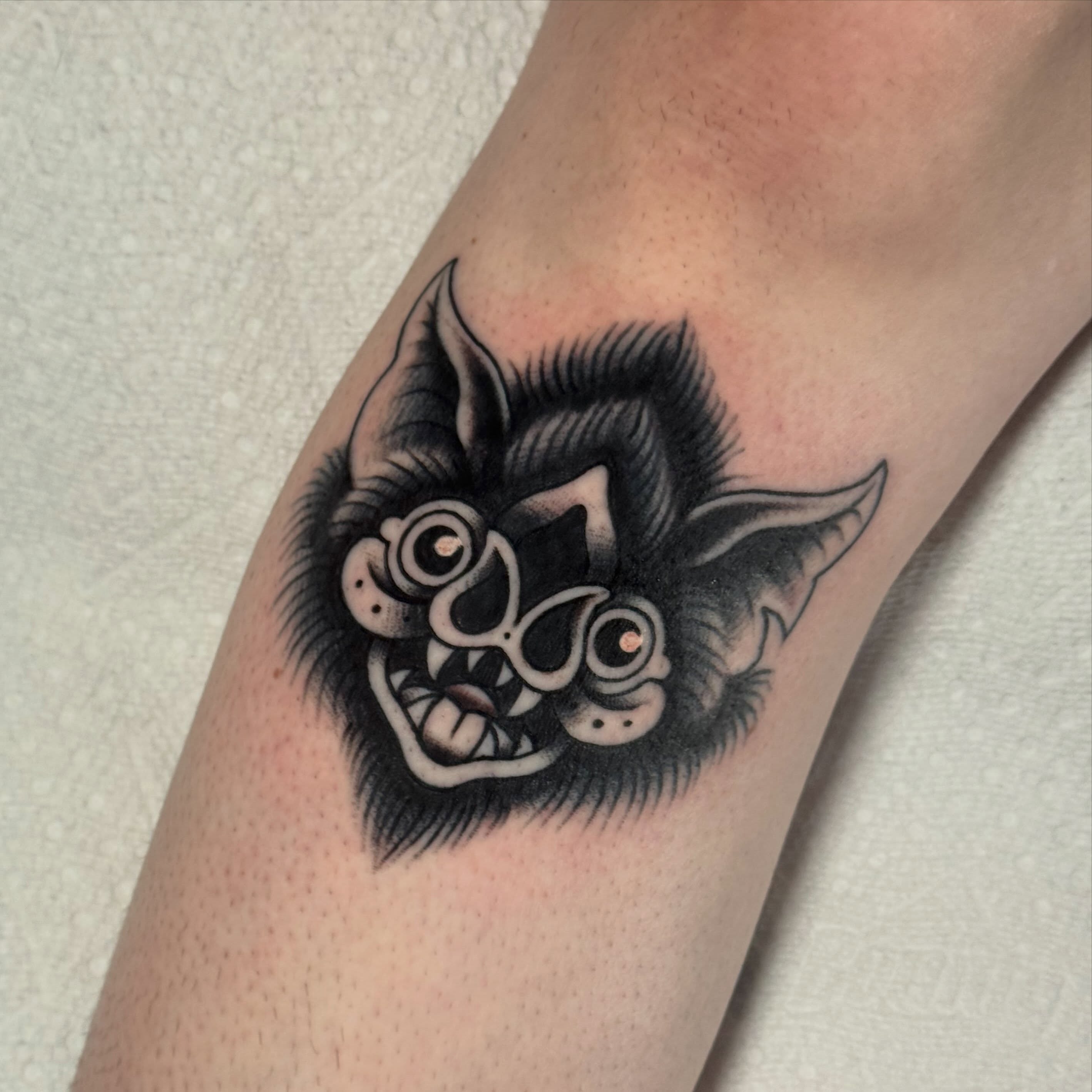 Bat black and grey tattoo on the forearm by Painted Peach Tattooer