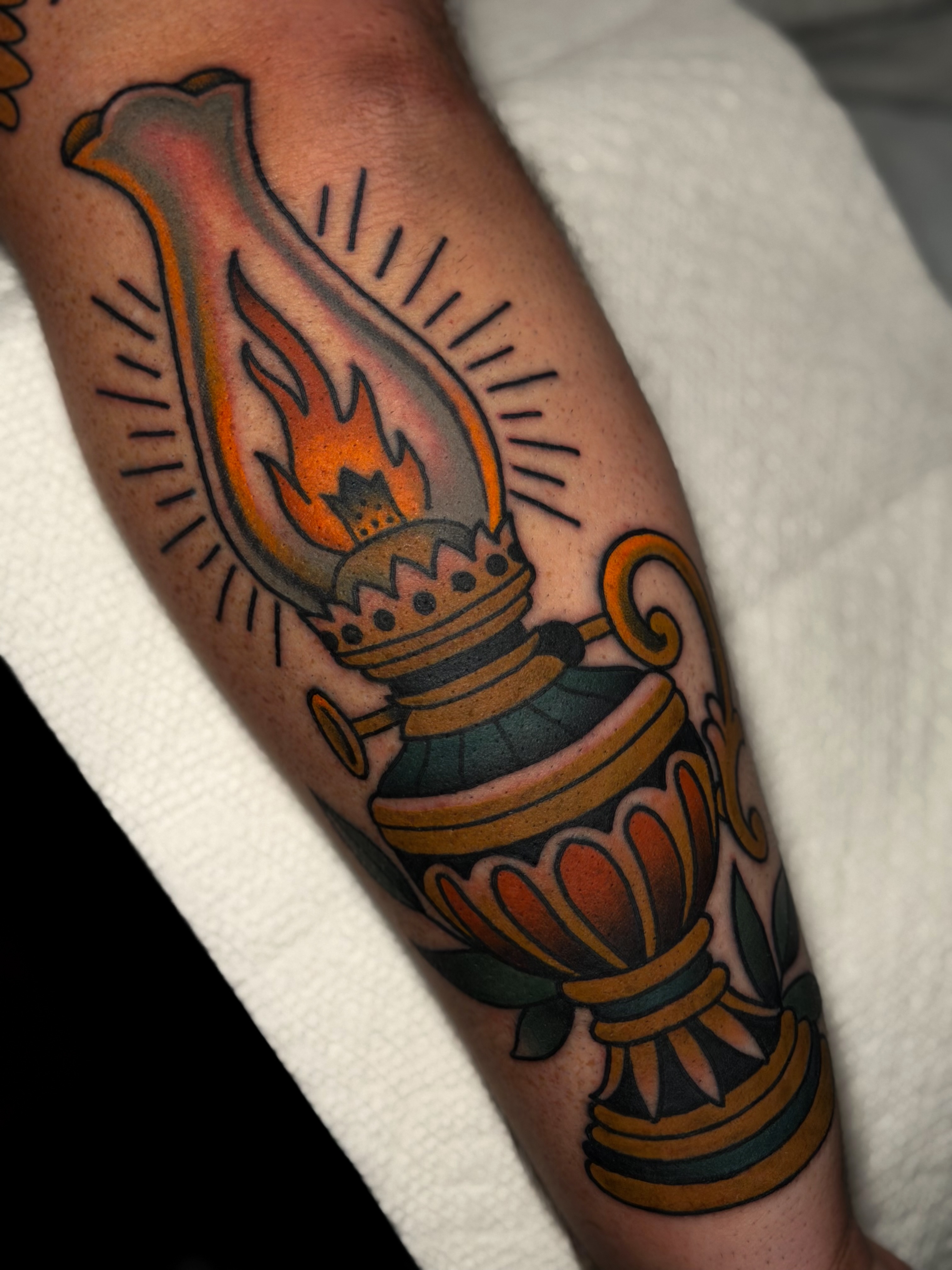Lamp with flame American traditional tattoo on the forearm by Cory Cartwright