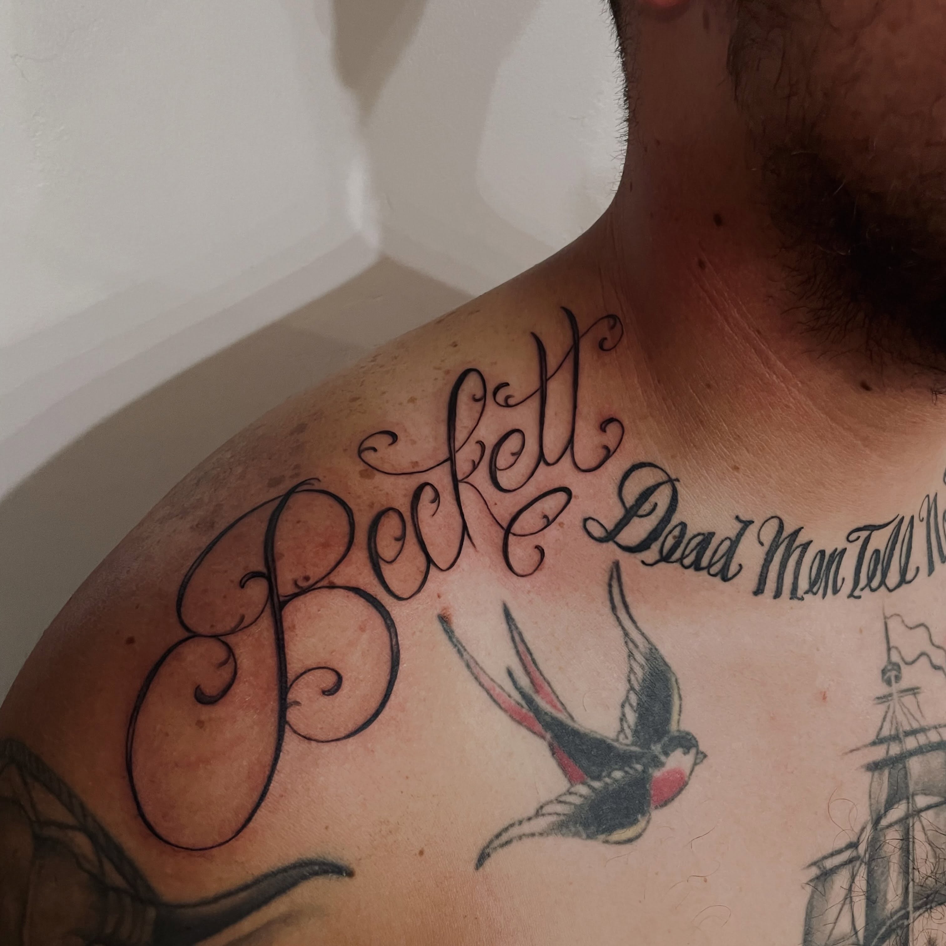 Beckett Dead Men Tell No Tales lettering script tattoo on the chest by Christien Xavier Alba, Salt Lake City, Utah