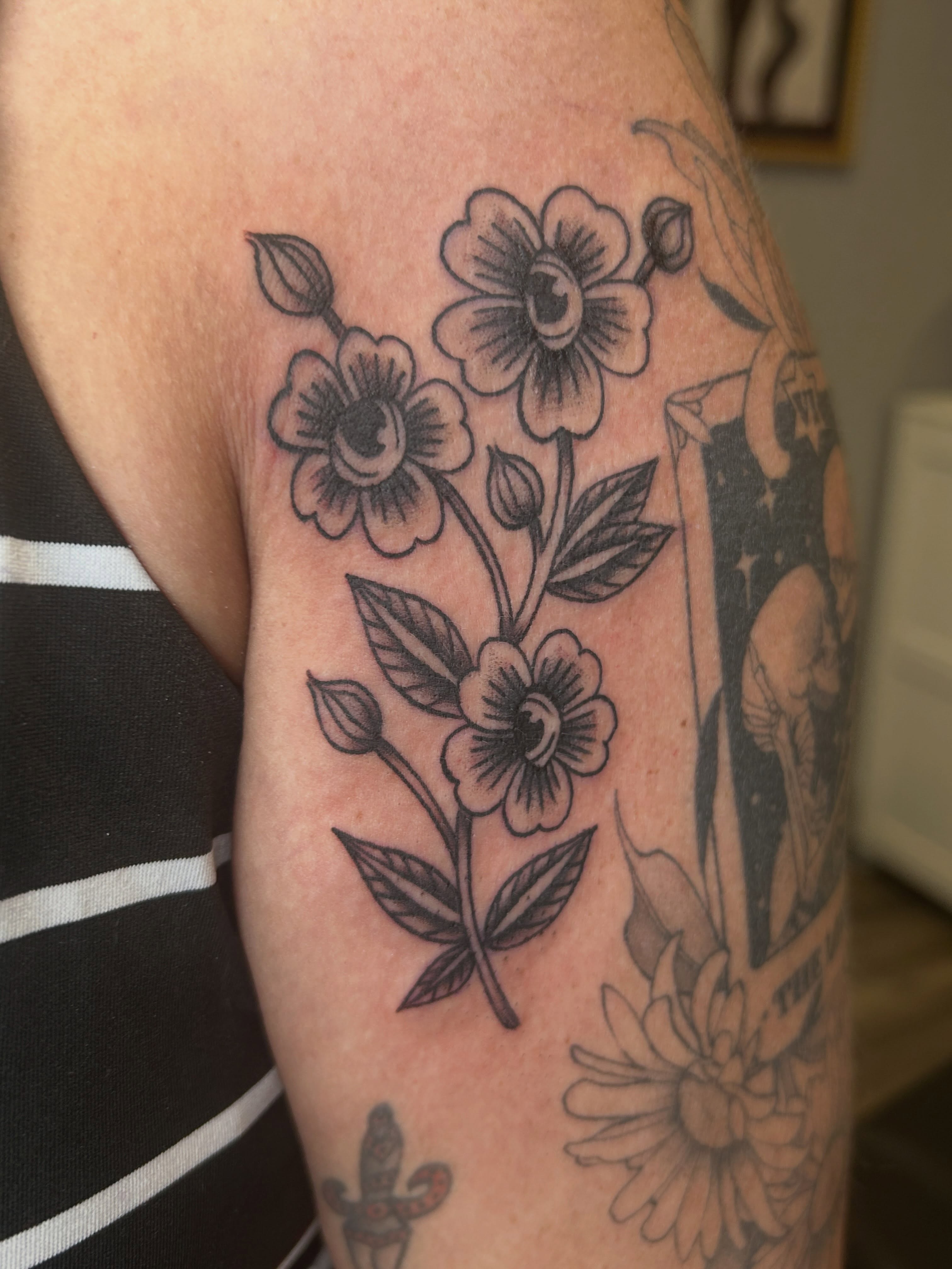 Flowers black and grey tattoo on the forearm by Janelle McCarthy