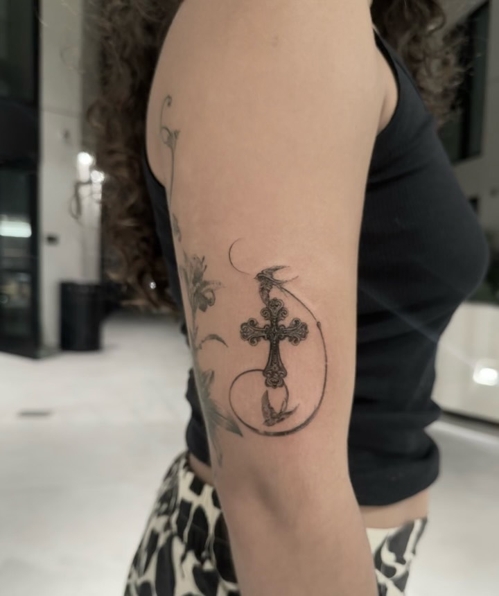 Cross ornamental tattoo on the forearm by Ava De La Torre
