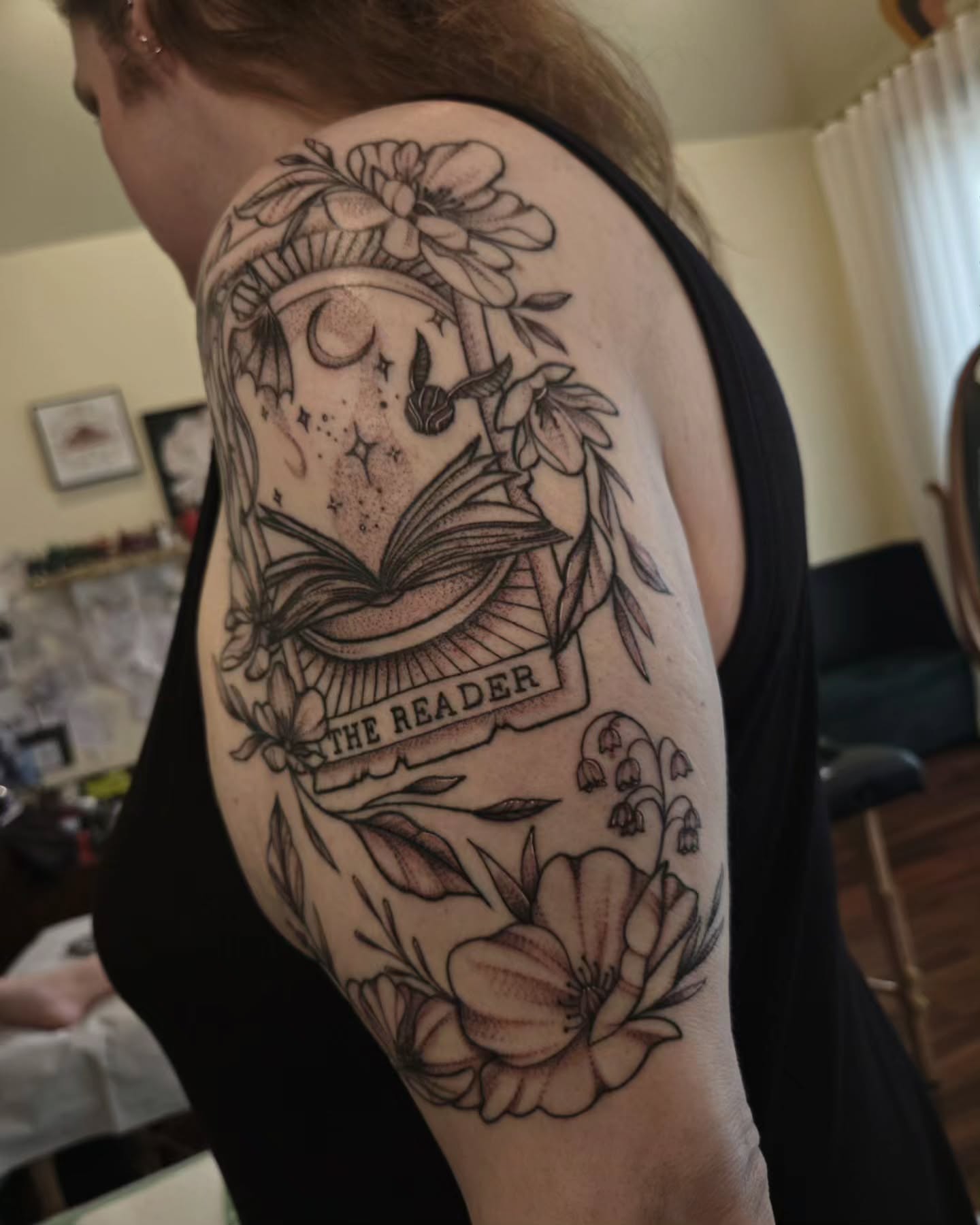 Book and flowers realism tattoo on the shoulder by jo(rdan)