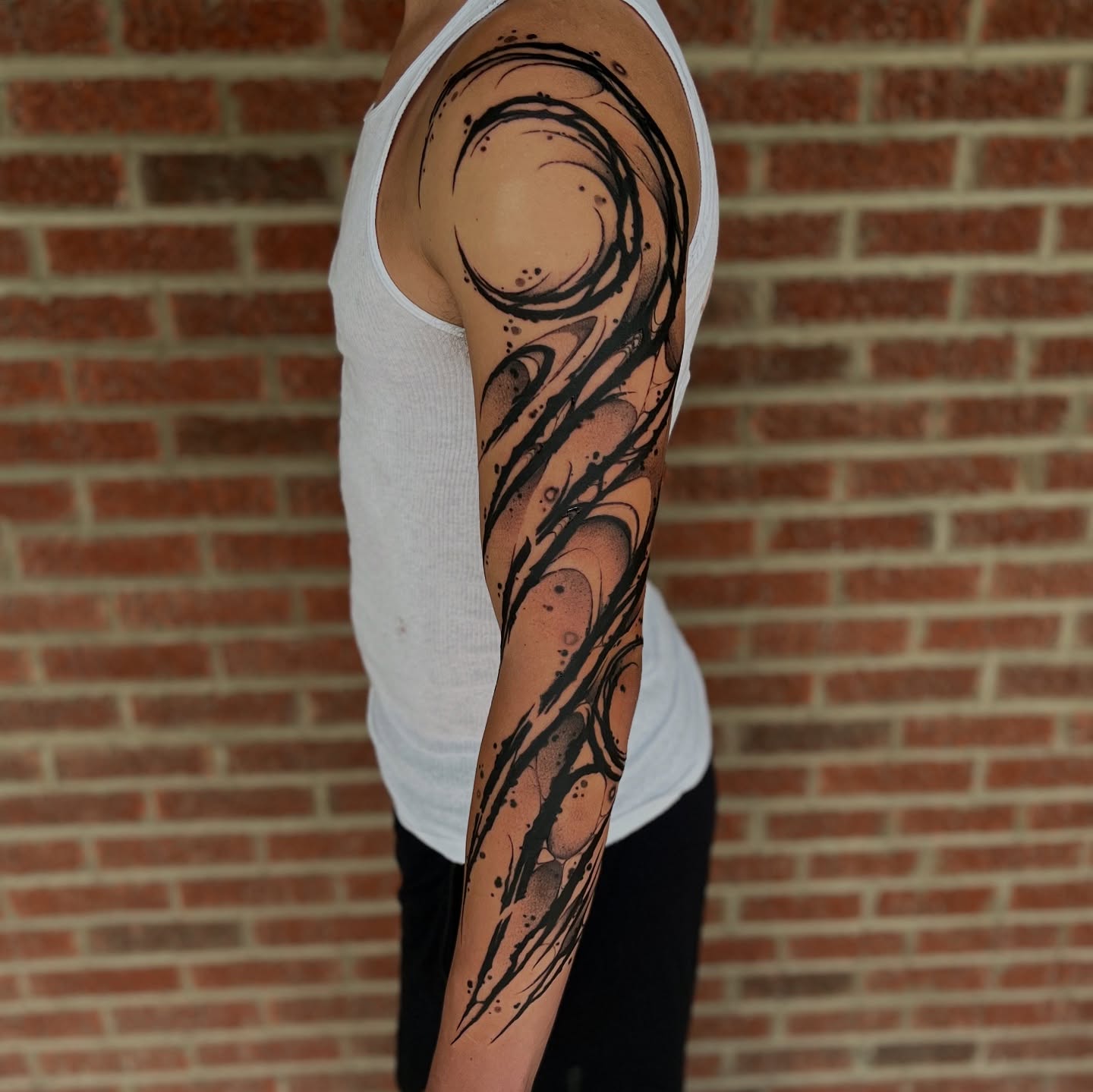 Abstract swirl dotwork tattoo on the forearm by Cameron Jenkins