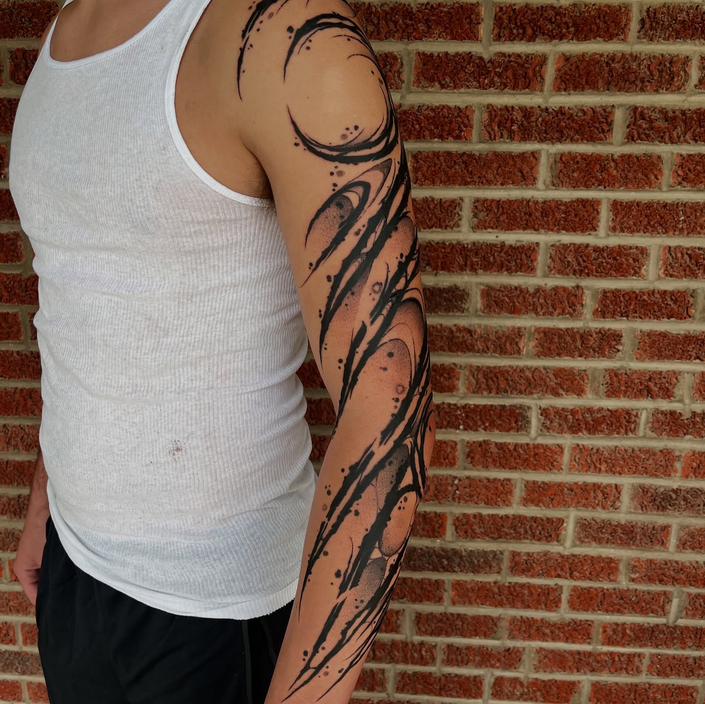 Tribal tribal tattoo on the upper arm by Cameron Jenkins