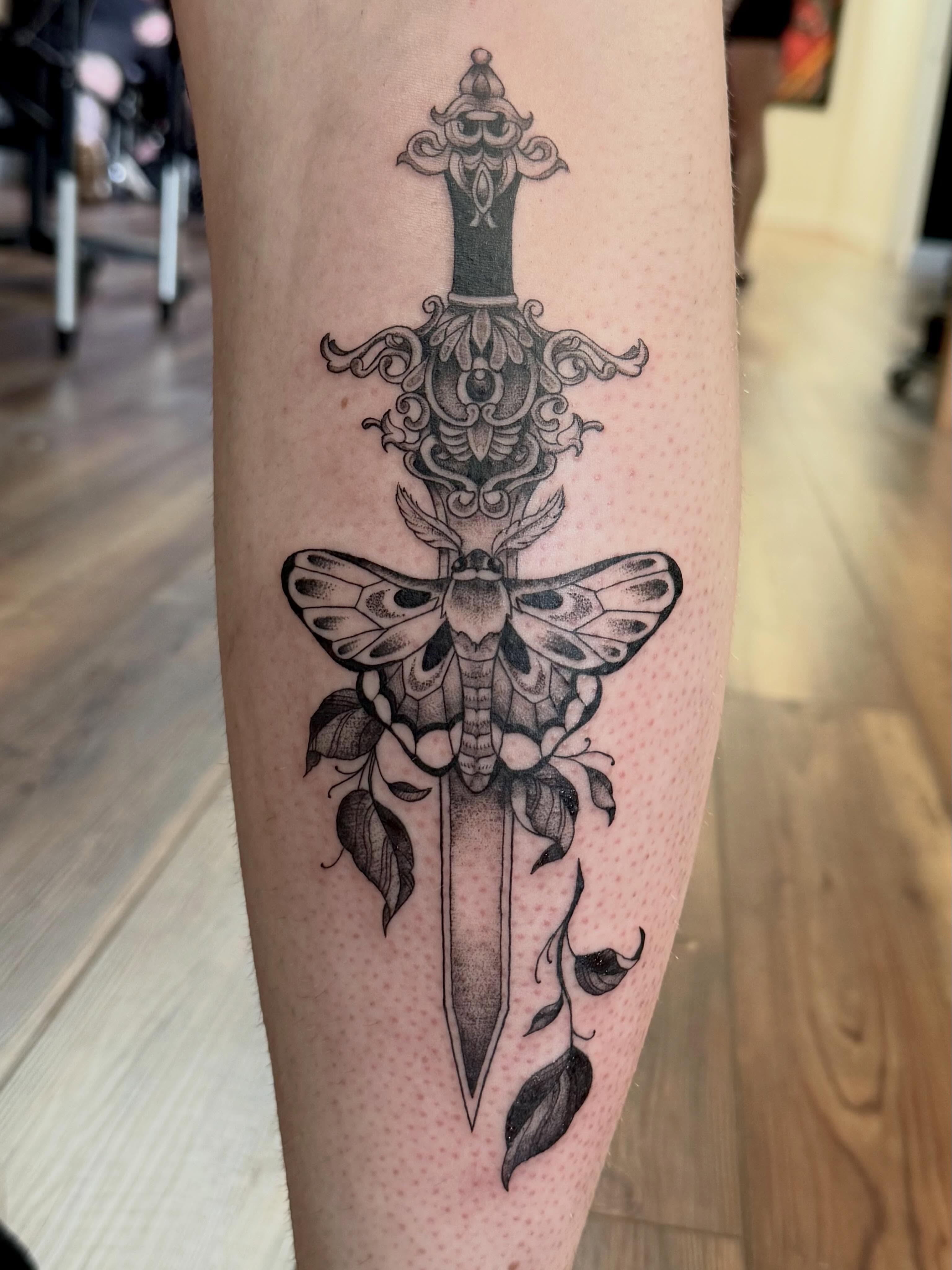 Moth and dagger dotwork tattoo on the forearm by Katie Stacy