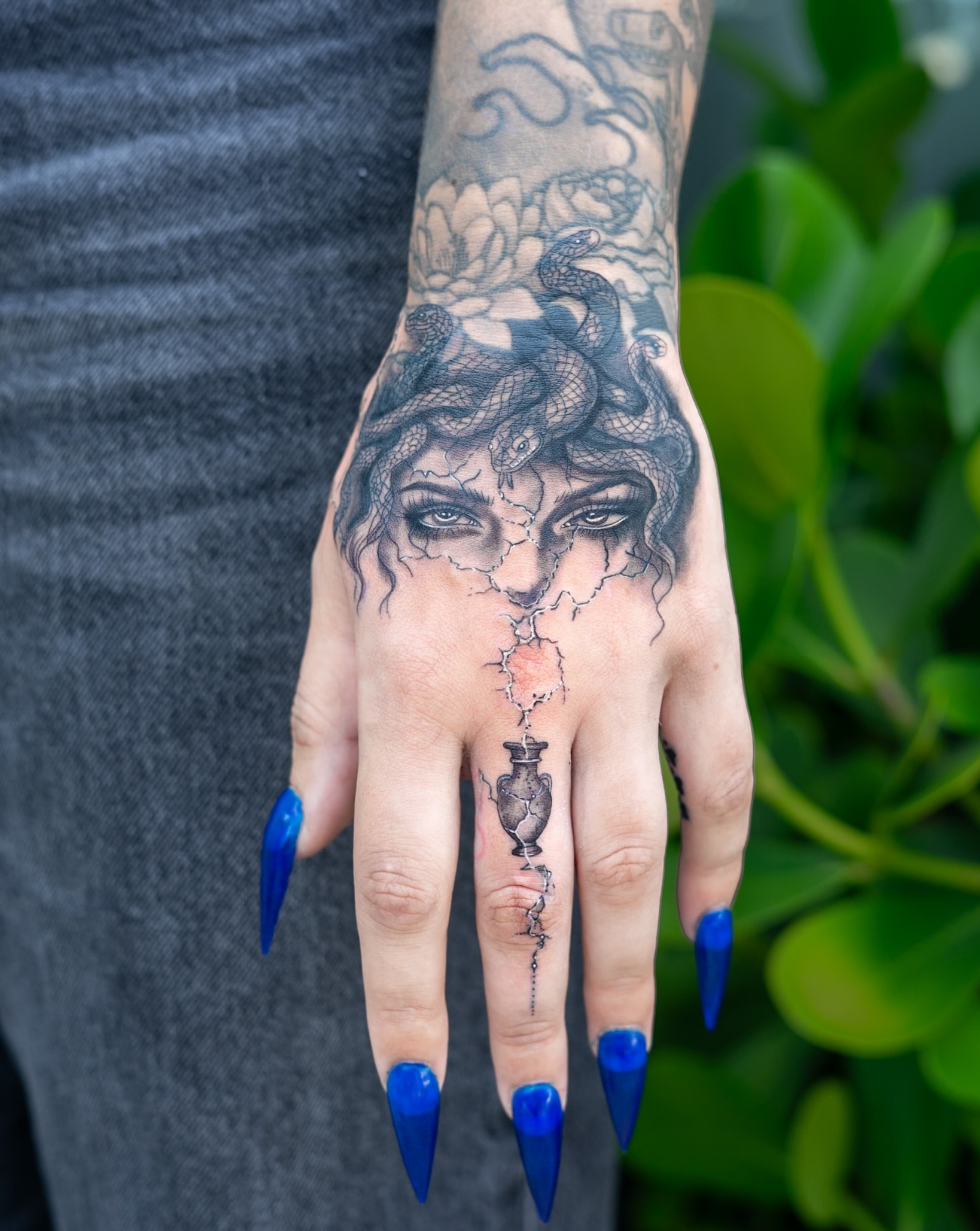 Woman with snakes realism tattoo on the hand by The Tattoo Plug