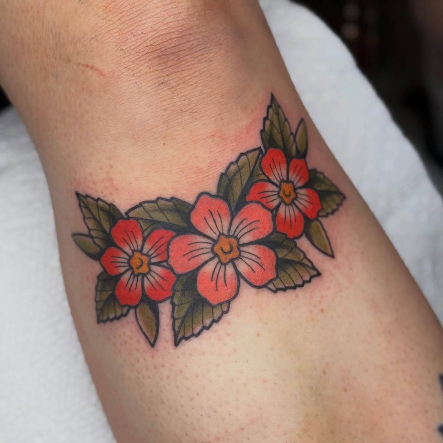 Flowers American traditional tattoo on the forearm by Jenna Szerszen-Wynn ๐