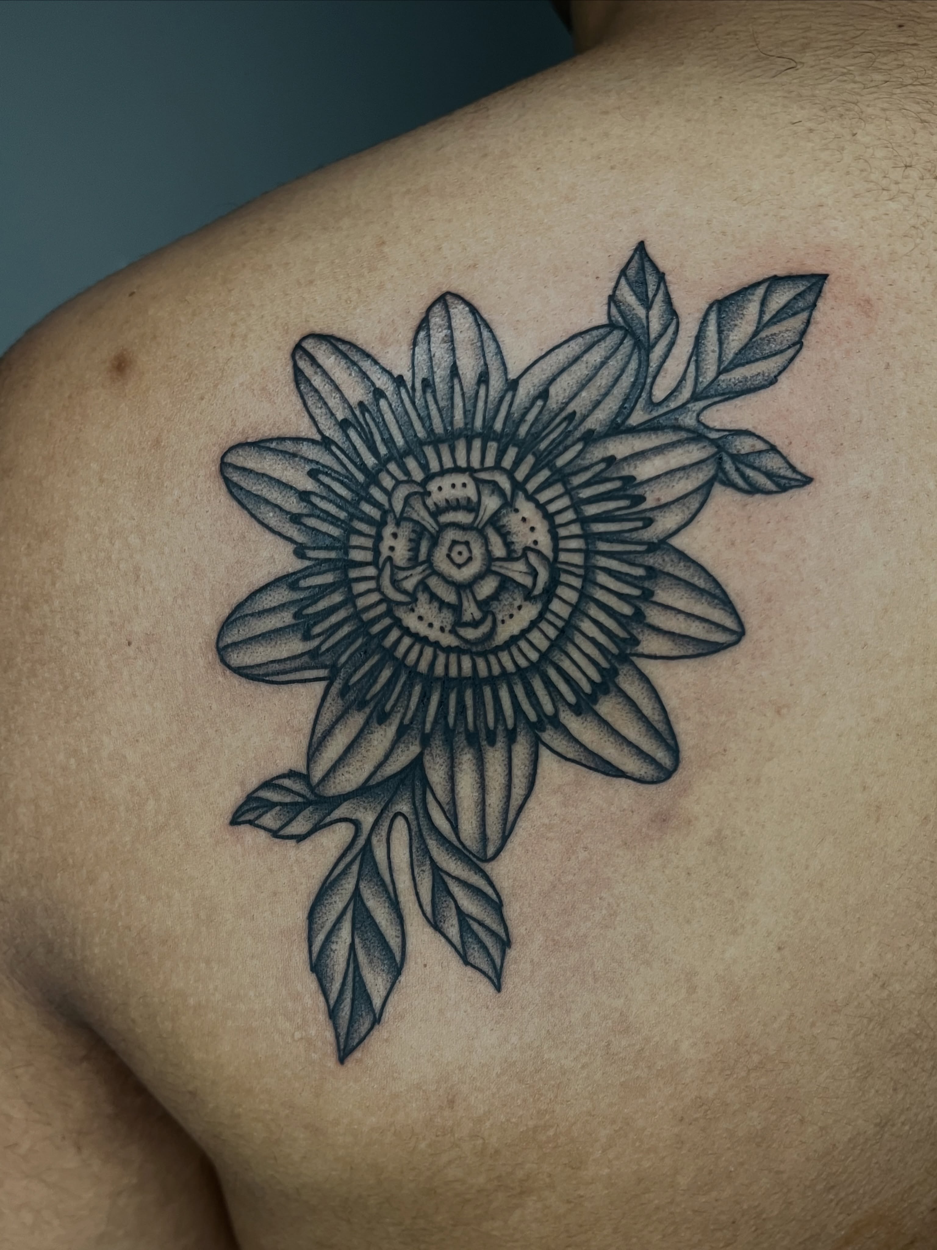 Passion flower dotwork tattoo on the shoulder by Patrick Elijah
