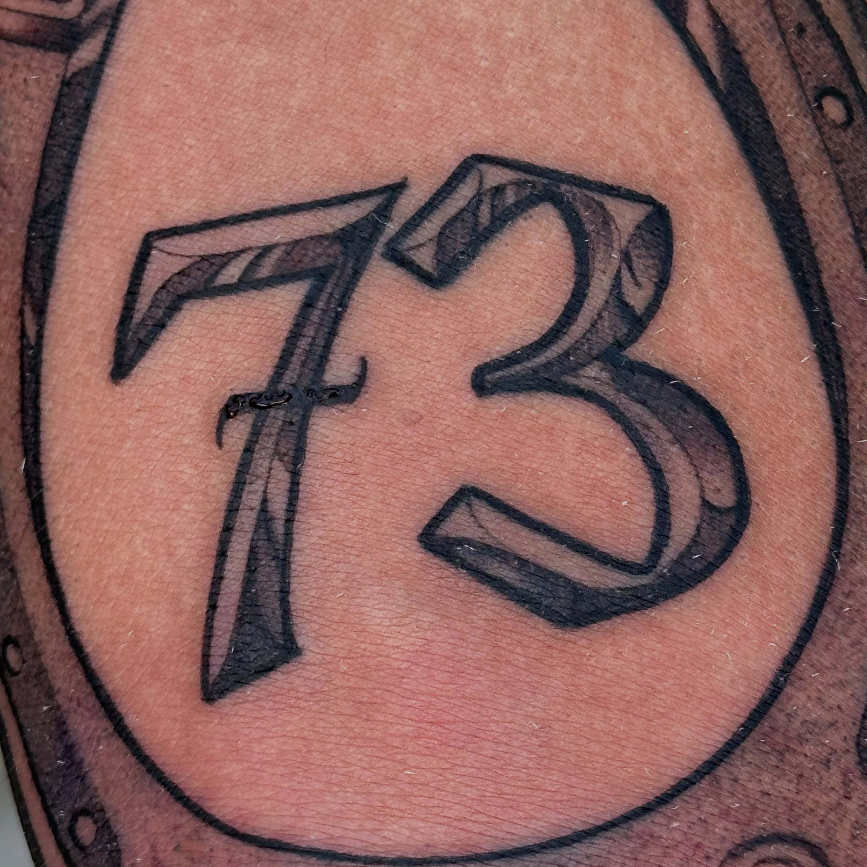 Number 73 lettering script tattoo by San Diego Tattoo Artist