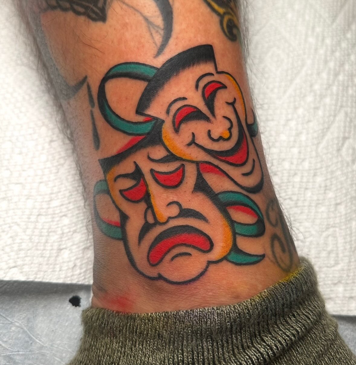 Clown faces American traditional tattoo on the forearm by Zahra Niedermann