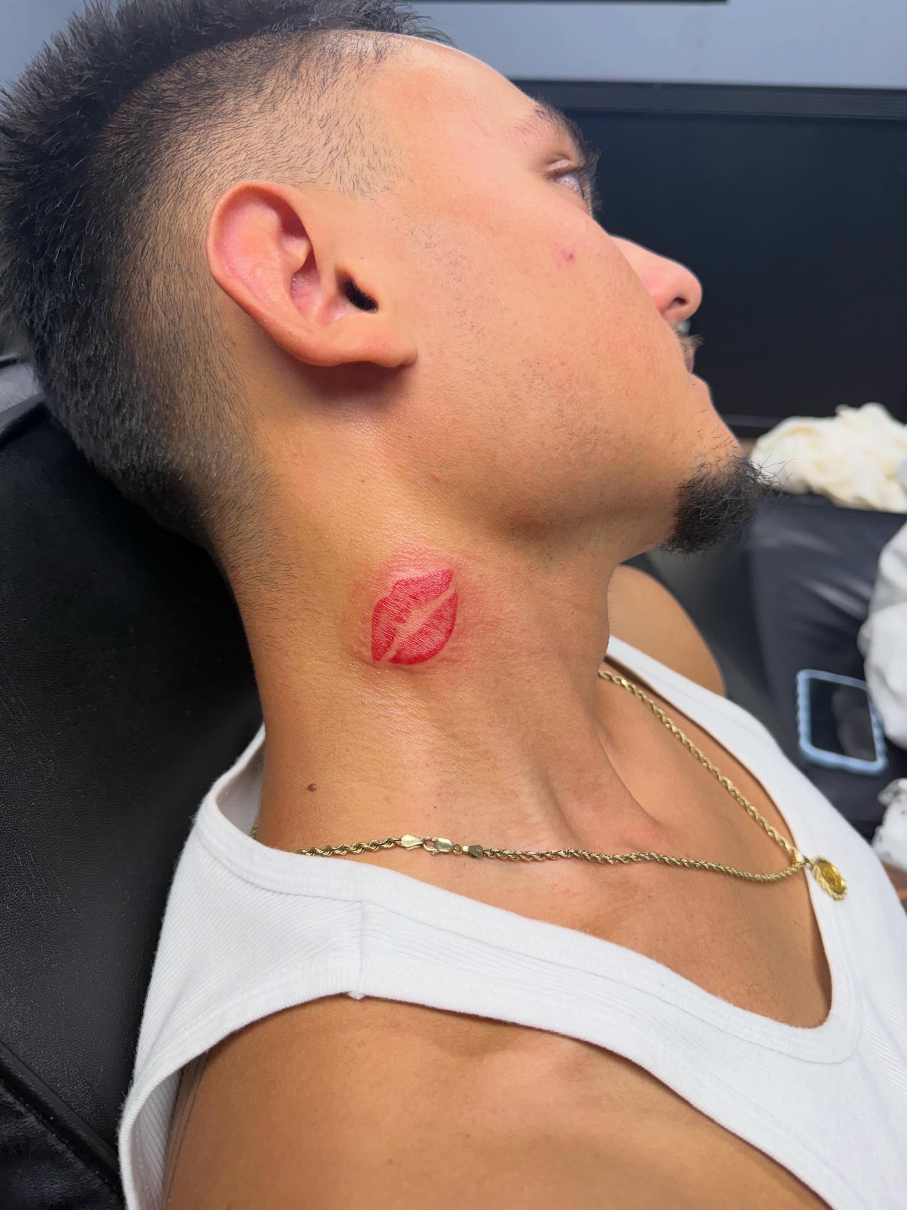 Lip print lettering script tattoo on the neck by Justin Evans kc ink