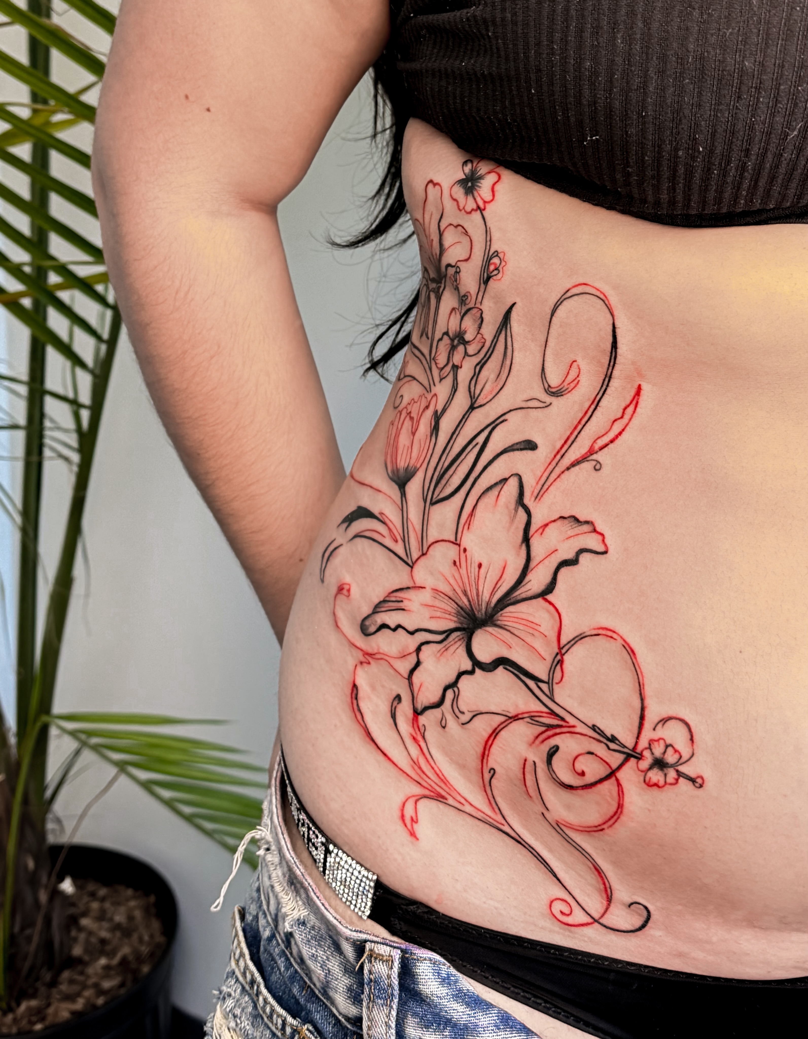 Floral design new school tattoo on the ribs by Tatuajes Denver