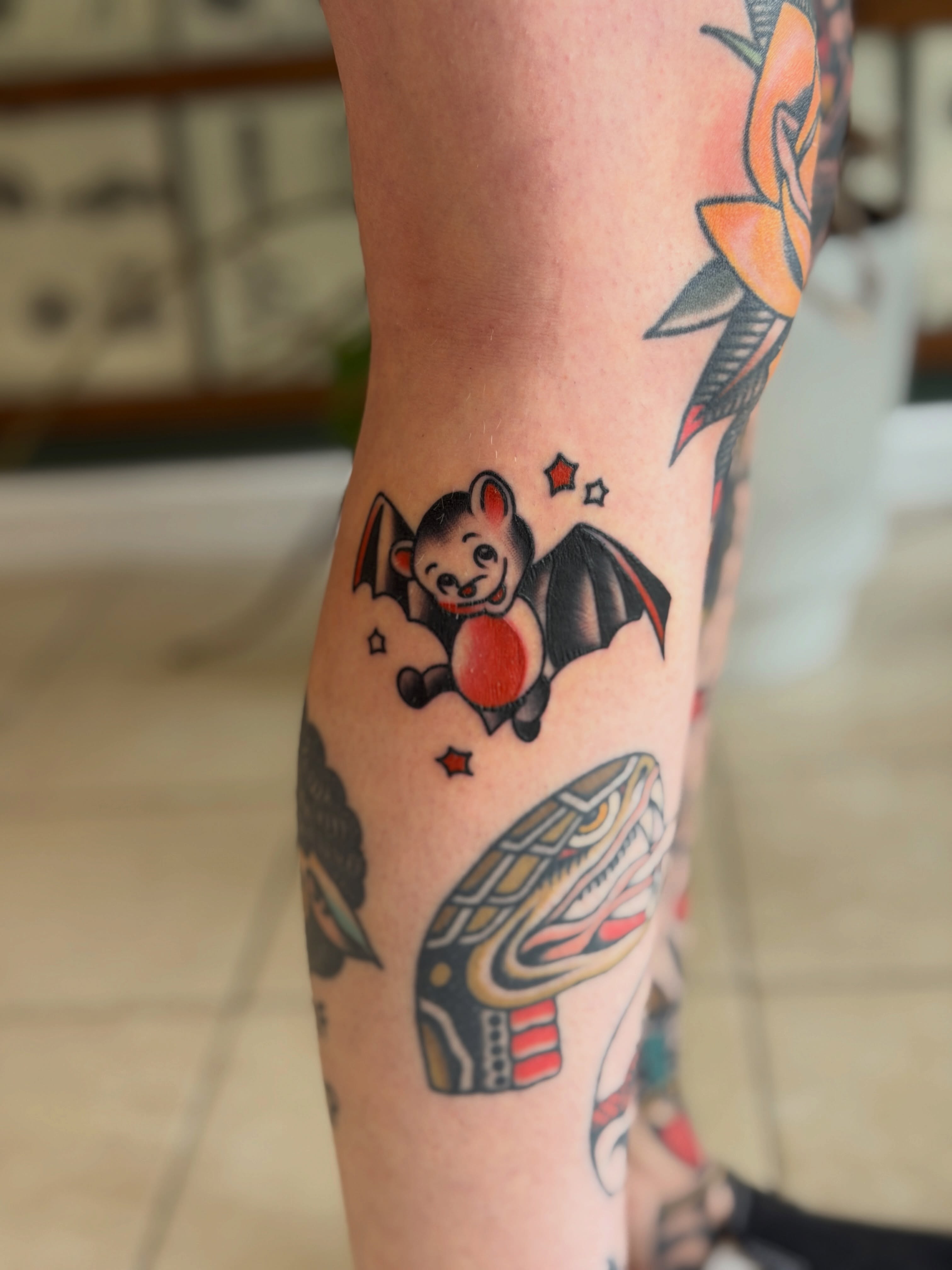 Bat holding heart American traditional tattoo on the forearm by Tyler Wright