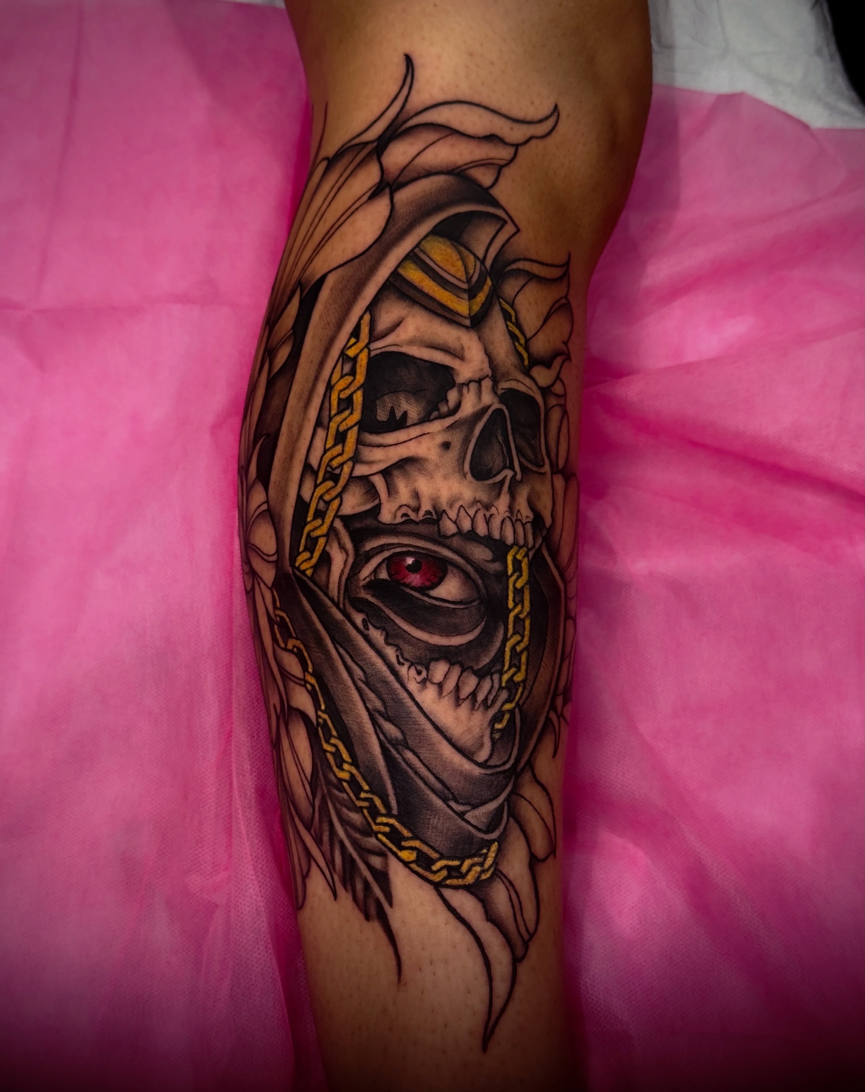 Skull with chain dark realism tattoo on the forearm by Jeff Brock