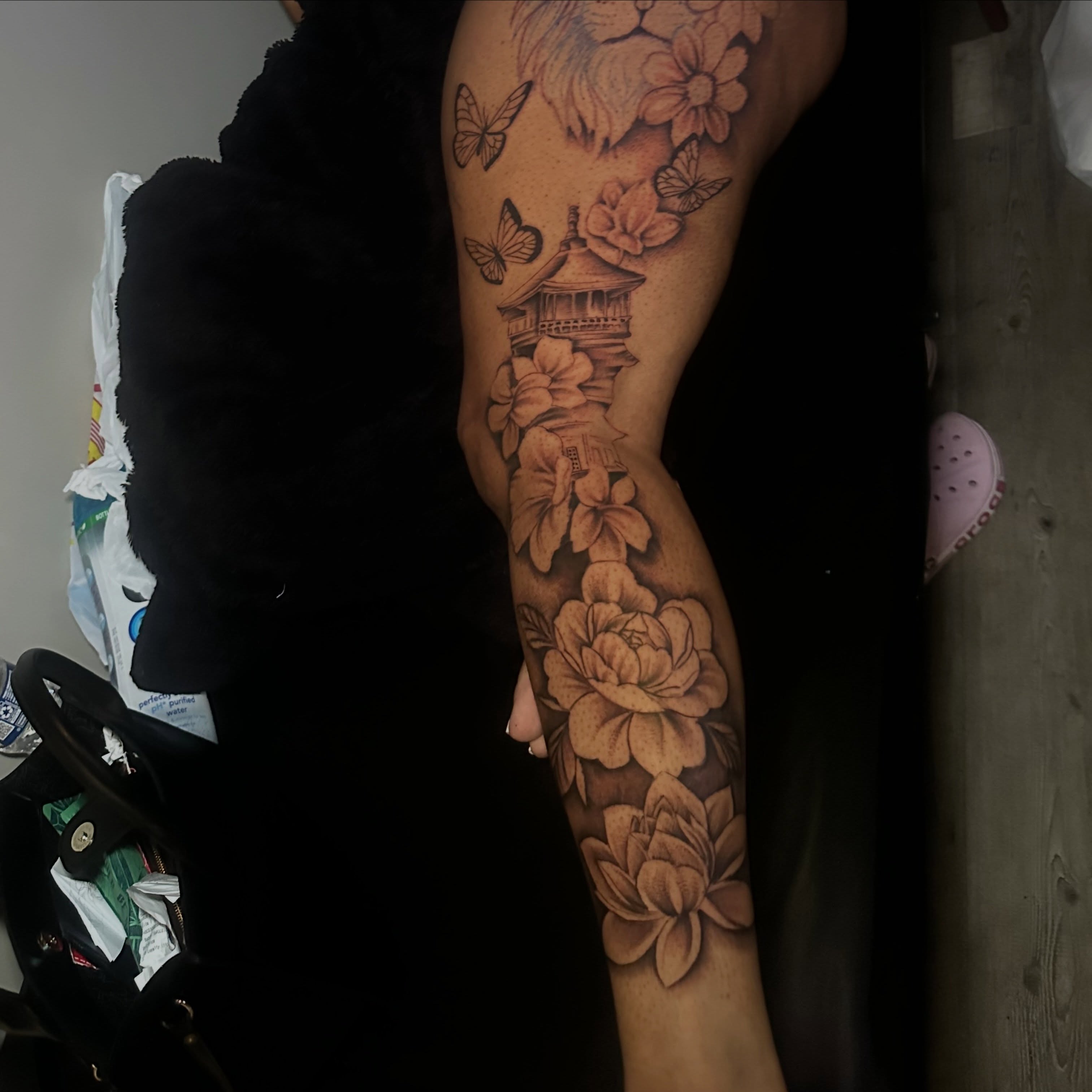 Pagoda and flowers black and grey tattoo on the forearm by @tattedbytuck