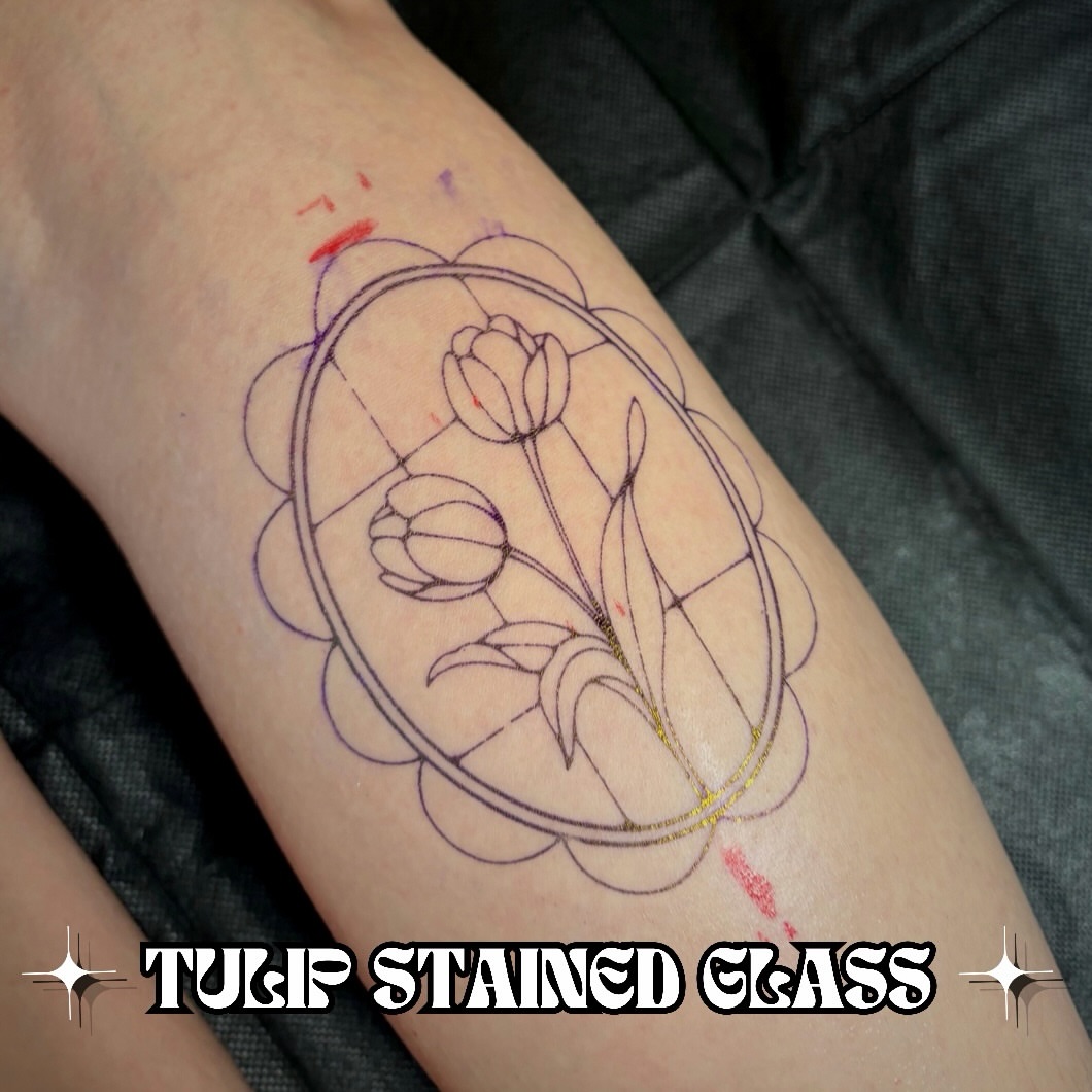 Tulip stained glass geometric tattoo on the forearm by Victoria Lamorte