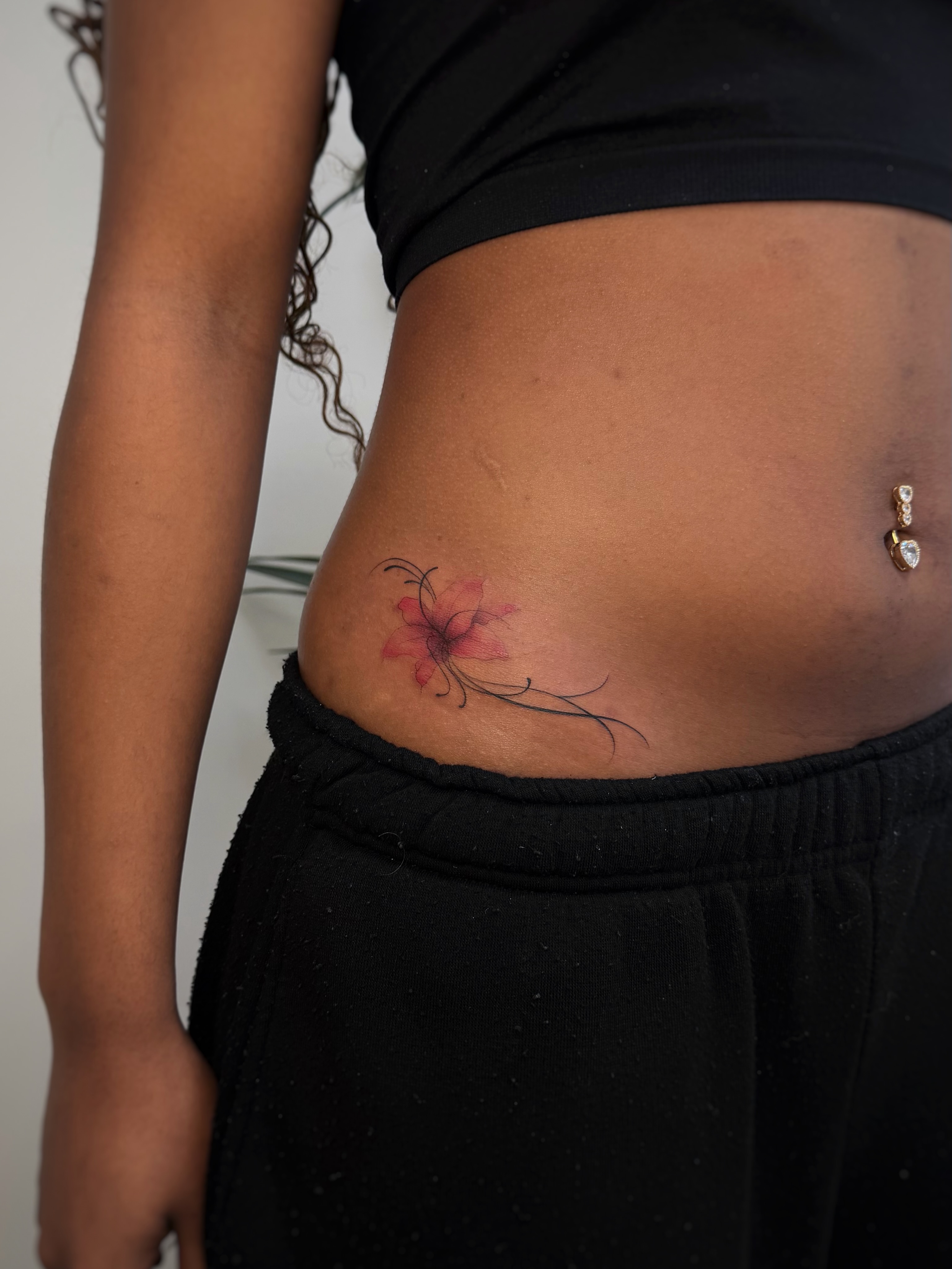 Flower fine line tattoo on the torso by David