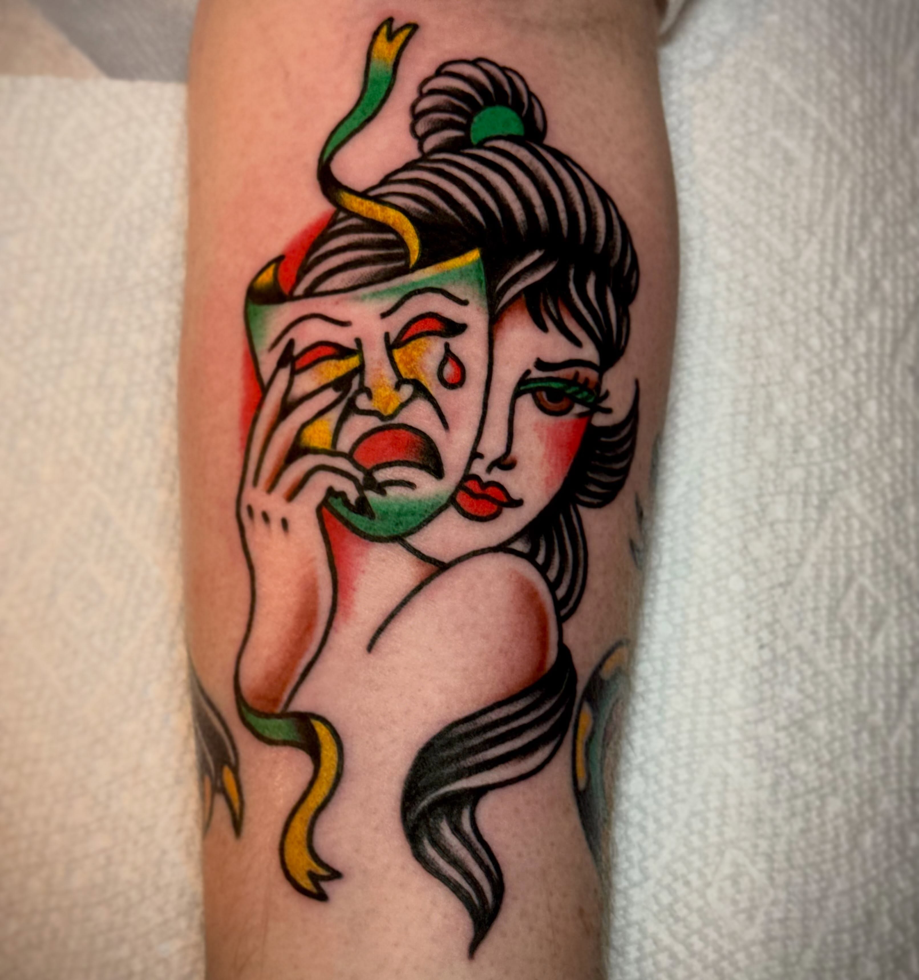 Woman with mask American traditional tattoo on the forearm by Eli Bernal