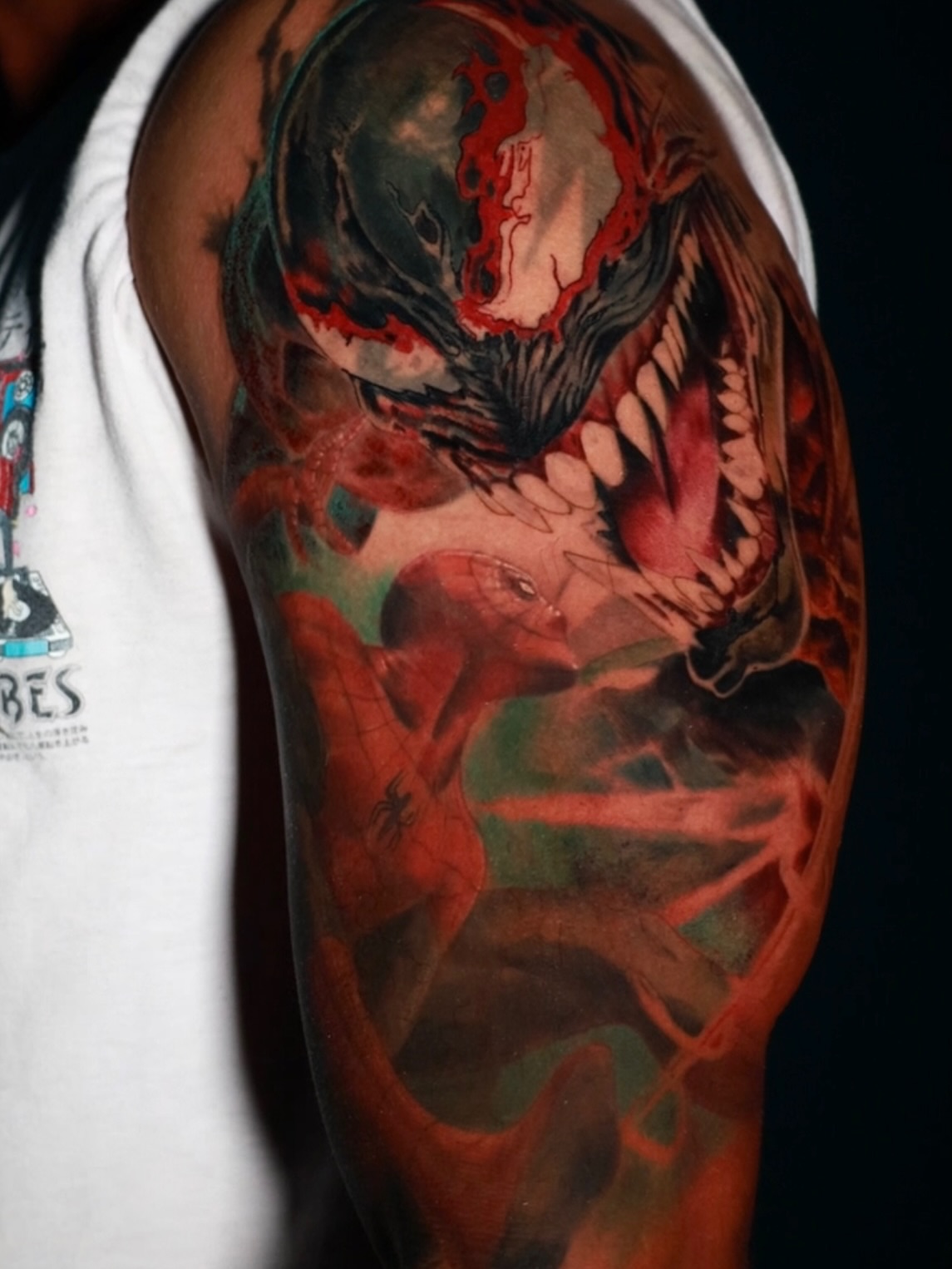 Venom and Spider-Man realism tattoo on the upper arm by Pigmentpirate
