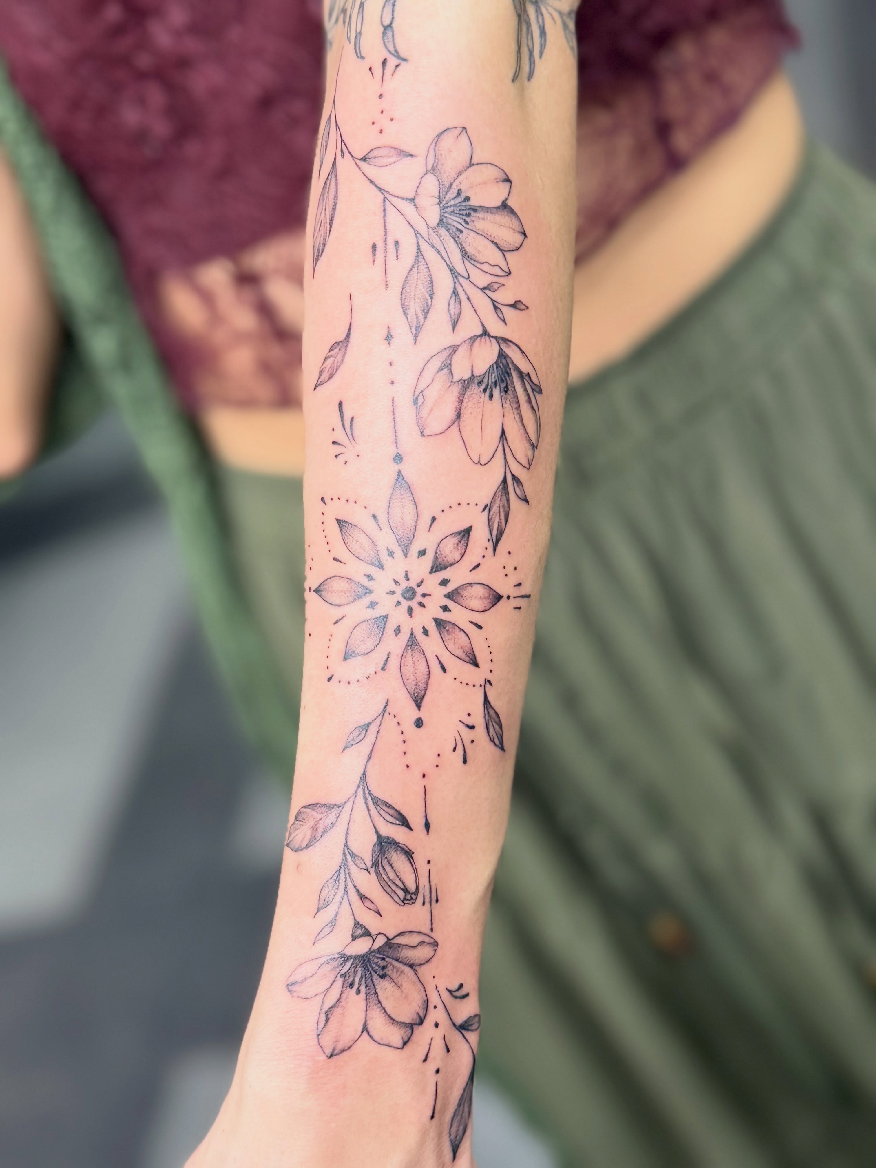 Floral mandala dotwork tattoo on the forearm by Tetiana