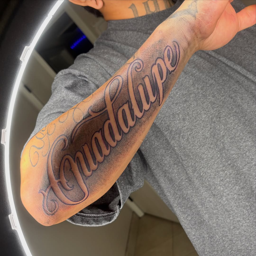 Guadalupe lettering script tattoo on the forearm by Las Vegas Tattoo Artist ๐ฒโ๏ธ