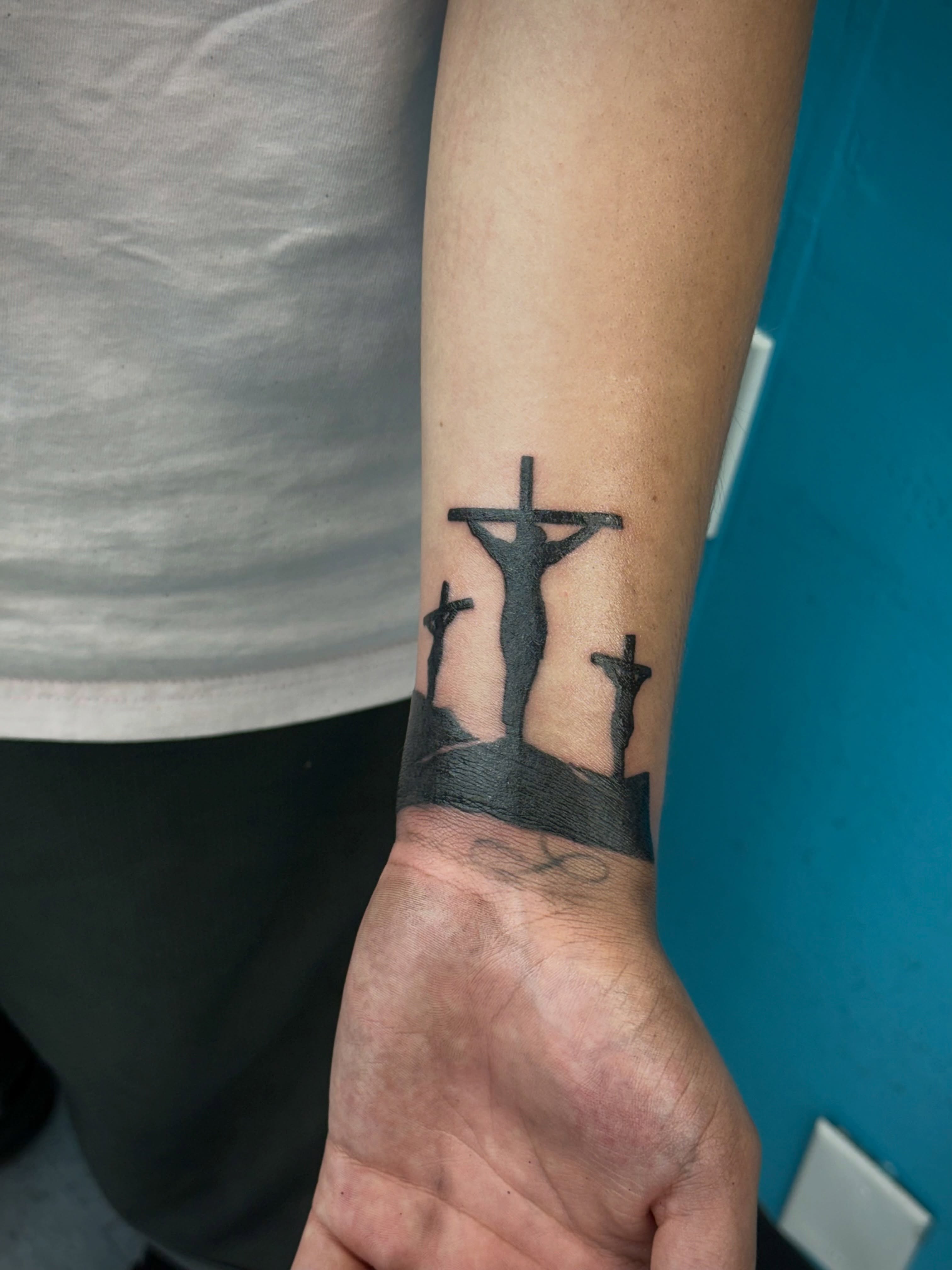 Statues on a hill black and grey tattoo on the forearm by ⠀Greave