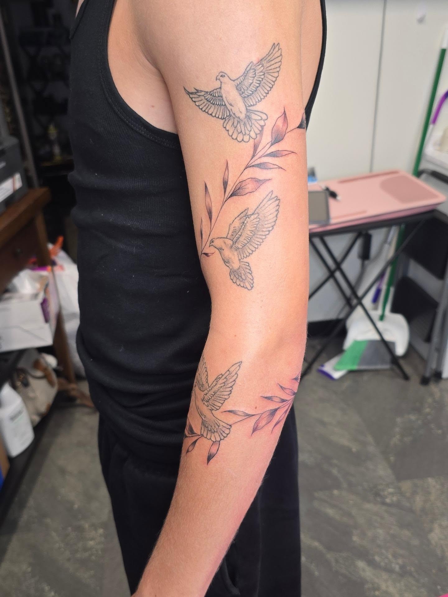 Birds and leaves fine line tattoo on the forearm by Val Sanchez
