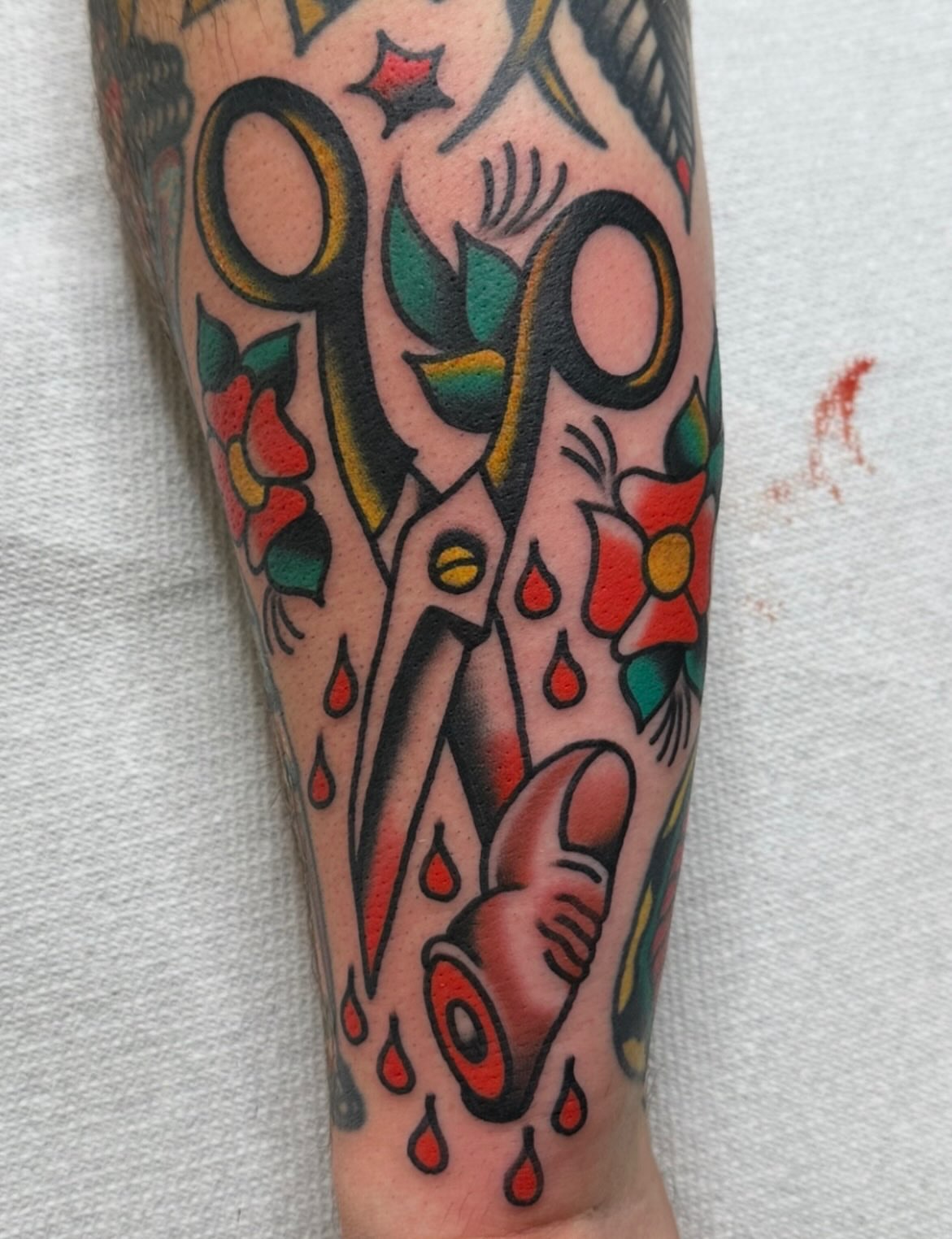 Scissors and flowers American traditional tattoo on the forearm by Steve Pearson