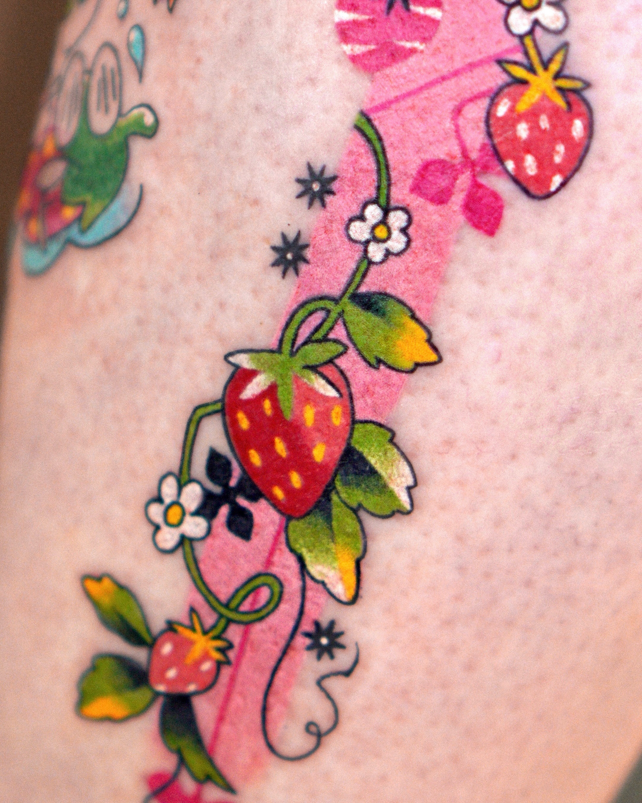 Strawberry vine American traditional tattoo on the thigh by Eden
