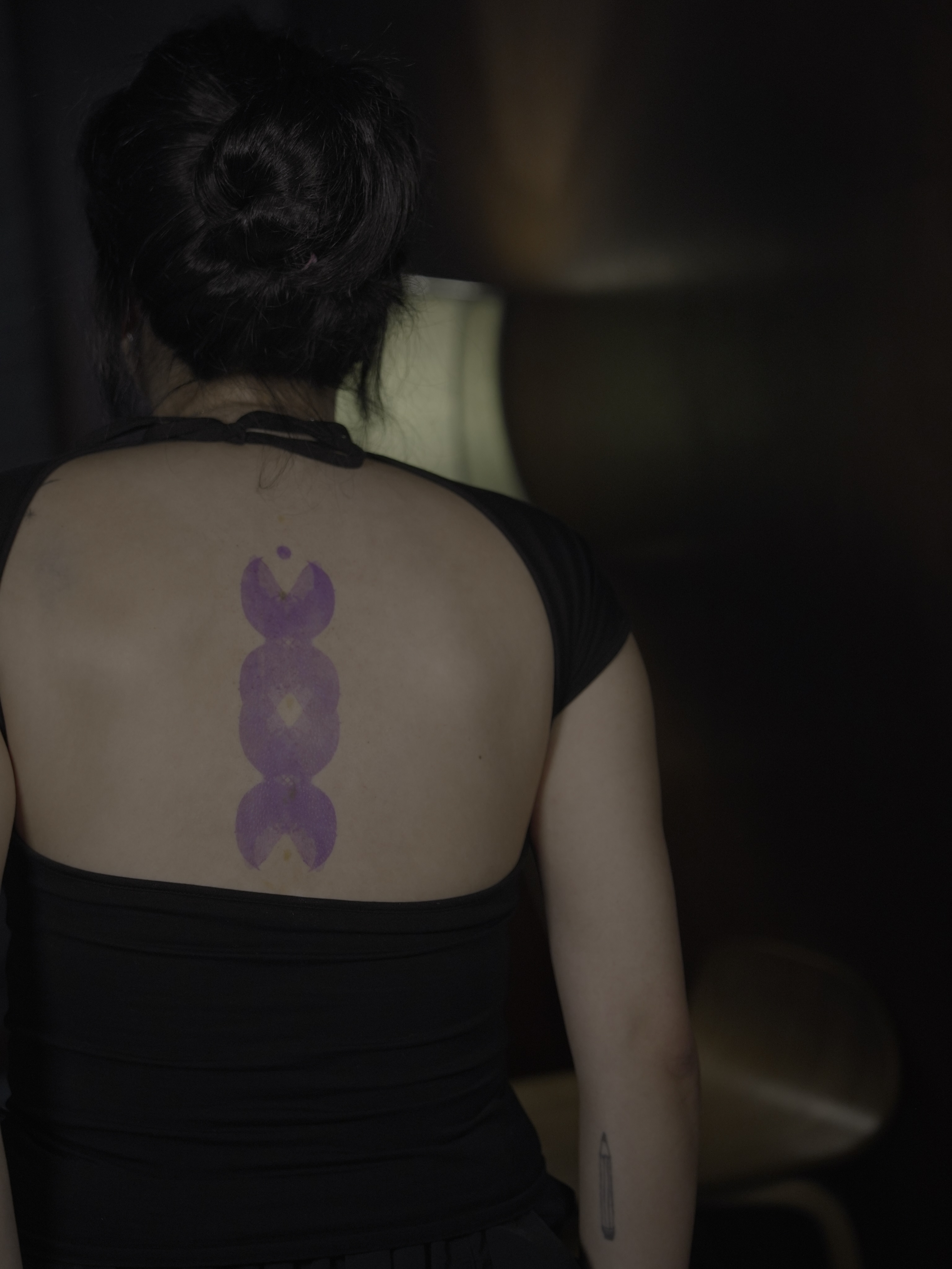 Purple abstract symbol geometric tattoo on the back by Blight