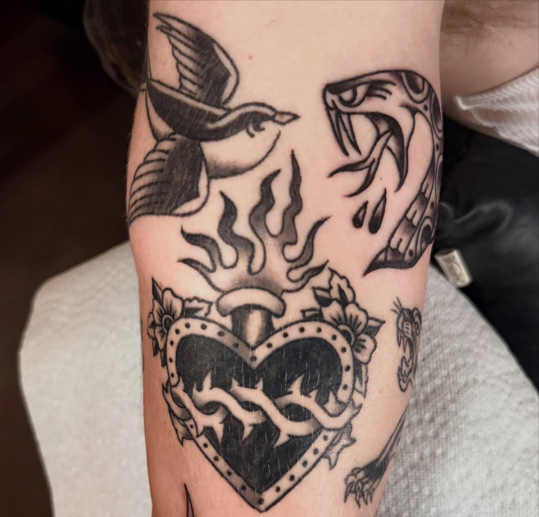 Heart with thorns American traditional tattoo on the forearm by Kelsey Turnis