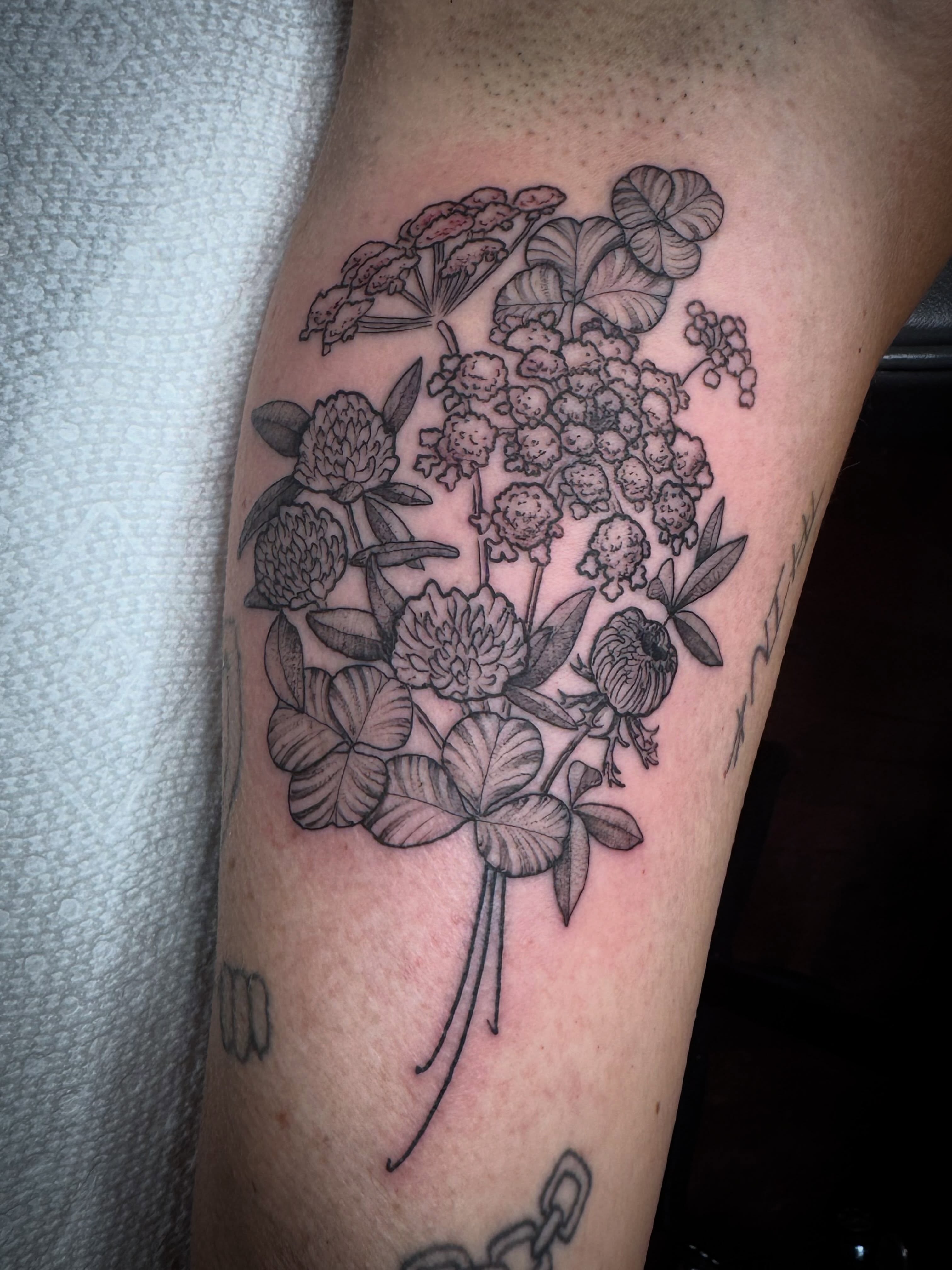 Floral bouquet black and grey tattoo on the forearm by 🏵