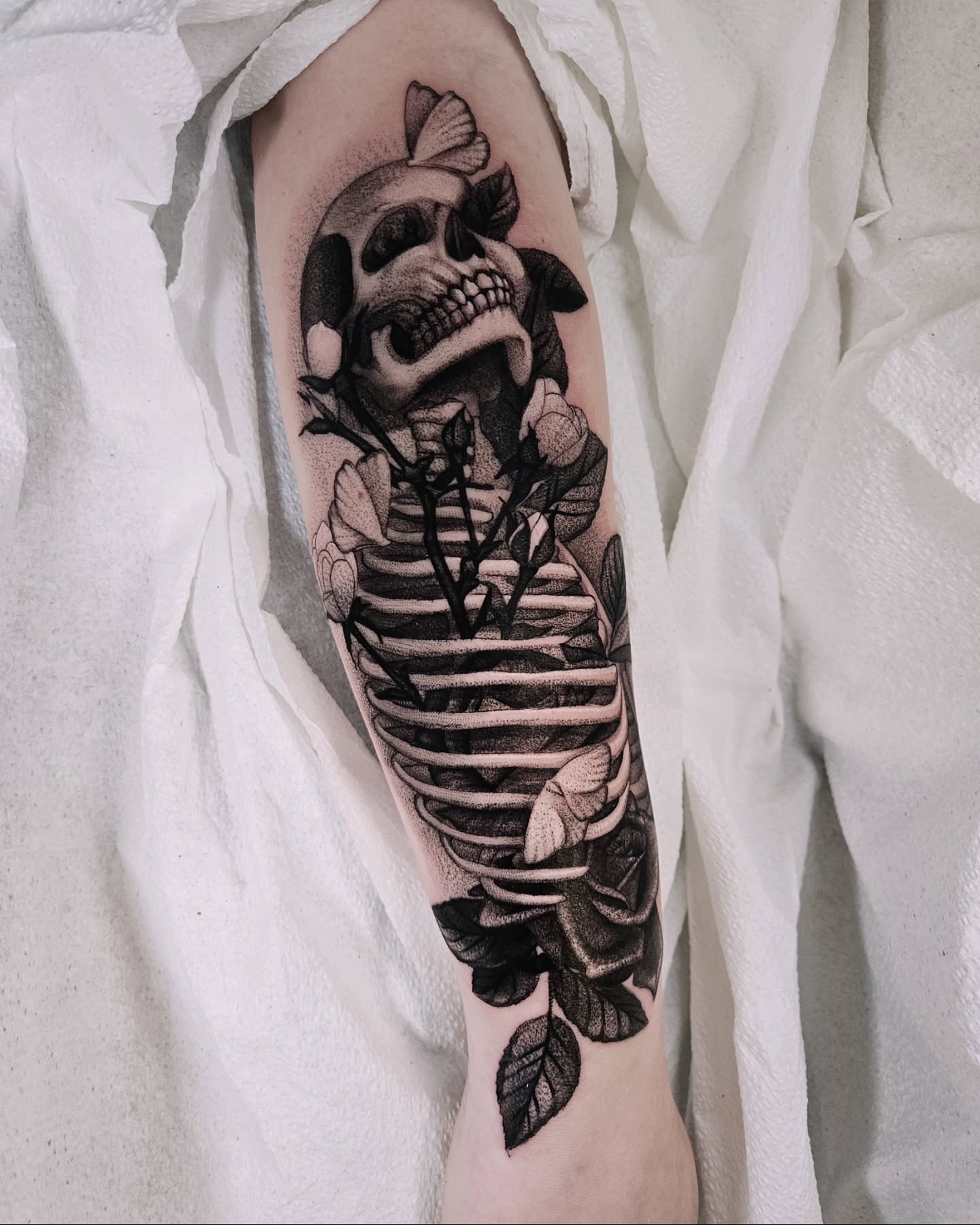 Skeleton with roses realism tattoo on the forearm by Sabrina Wagner