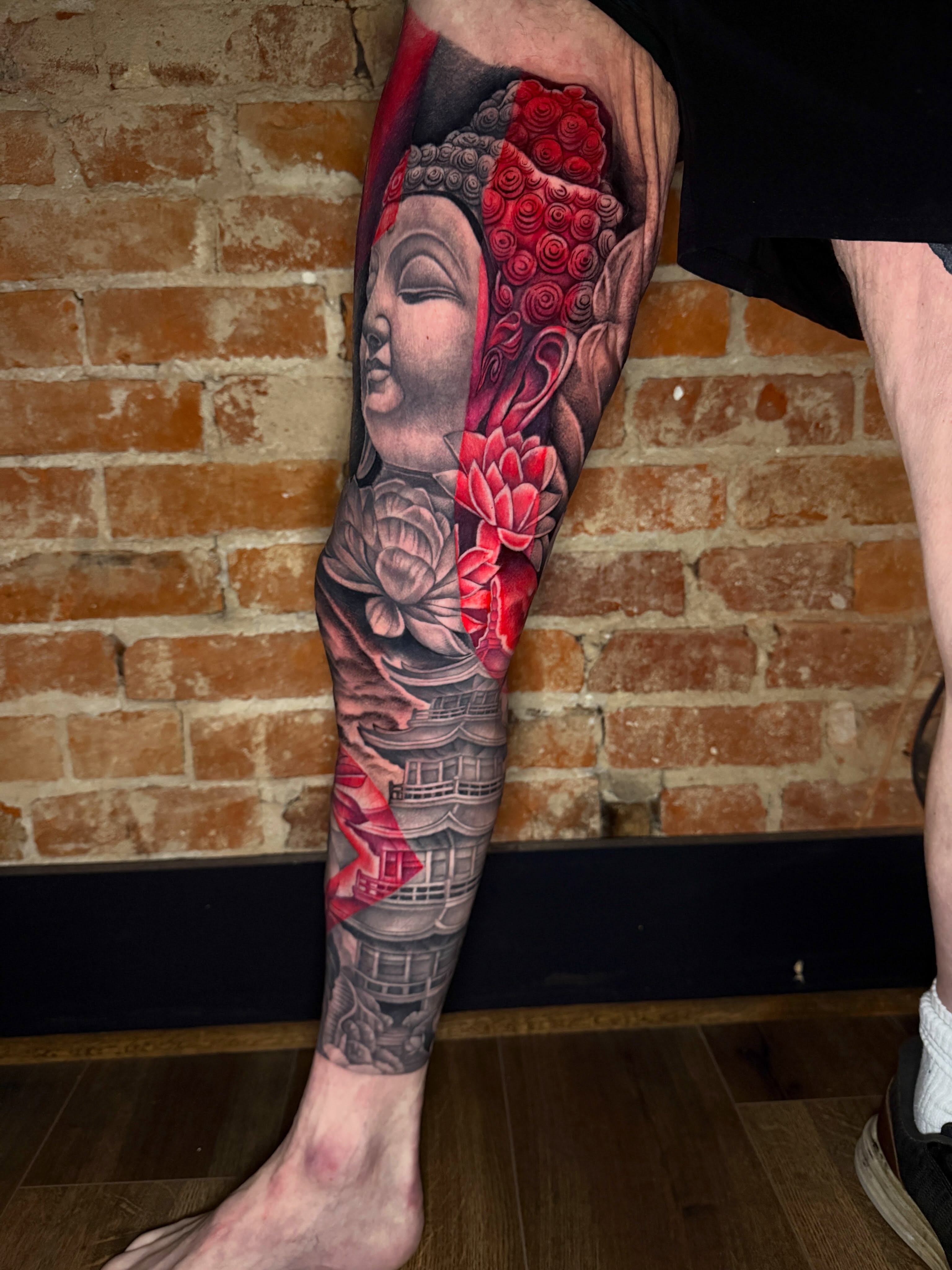 Buddha with lotus flowers japanese irezumi tattoo on the calf by Taylor Steckman