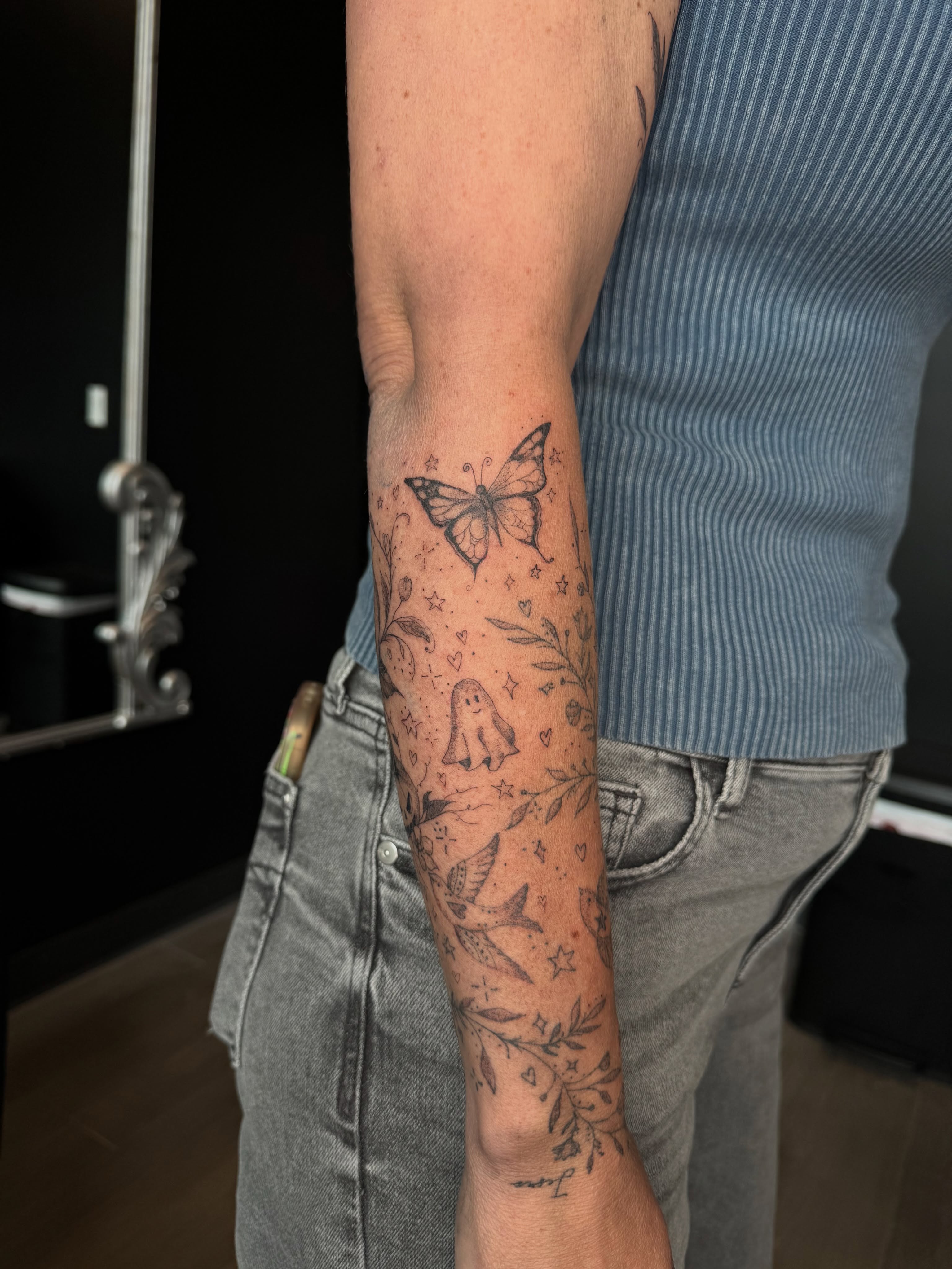 Butterfly and ghost black and grey tattoo on the forearm by Ryleigh Benjamin