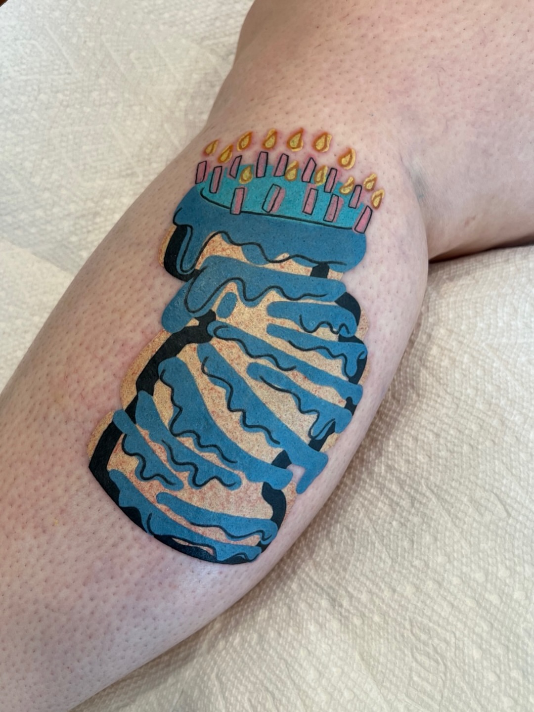 Birthday cake new school tattoo on the forearm by Tattoo Artist