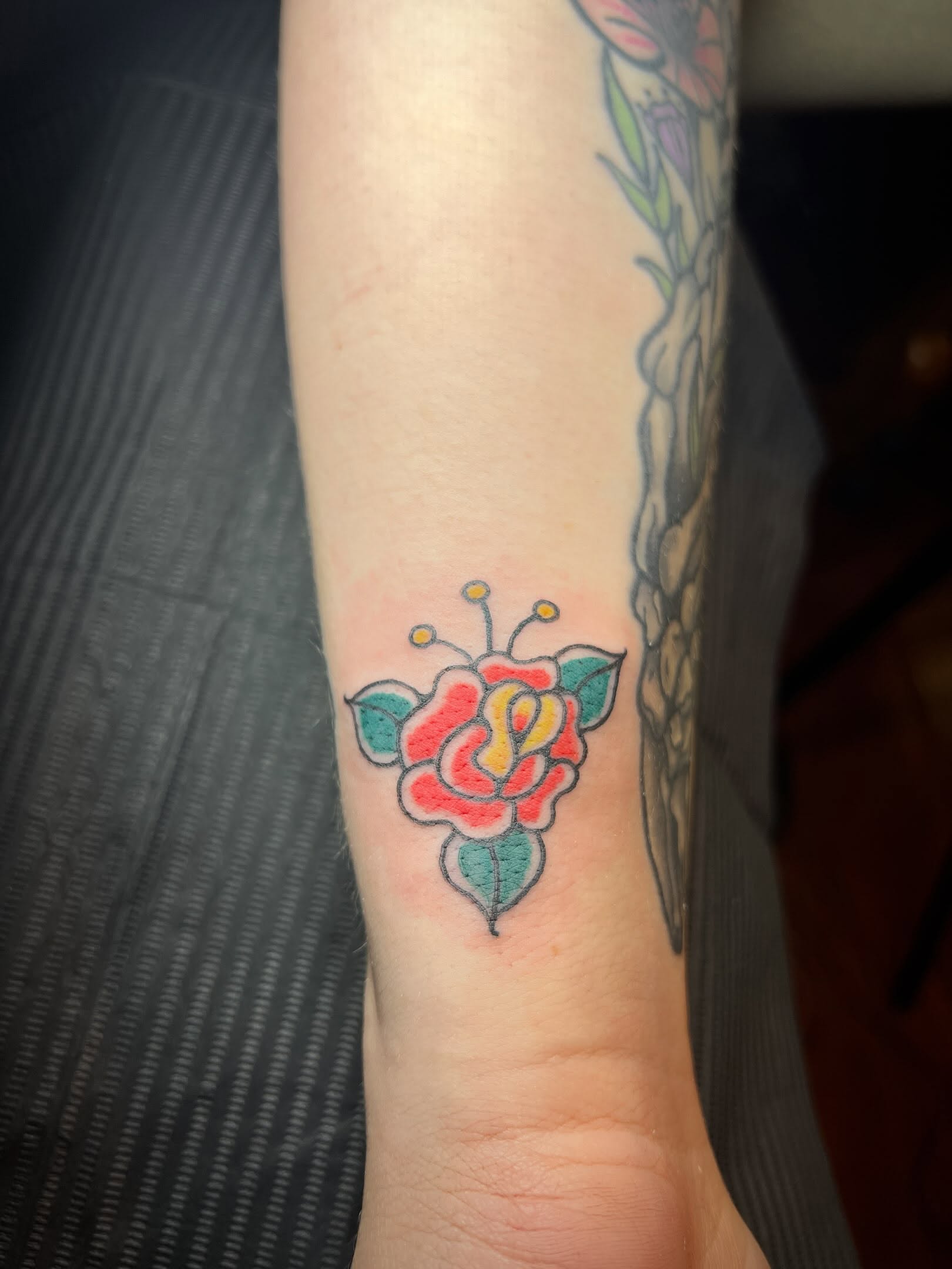 Flower American traditional tattoo on the forearm by Tattoo Kayla