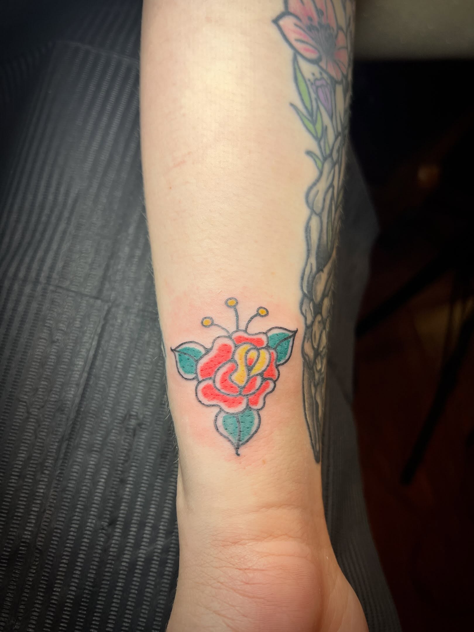 Flower American traditional tattoo on the forearm by Tattoo Kayla
