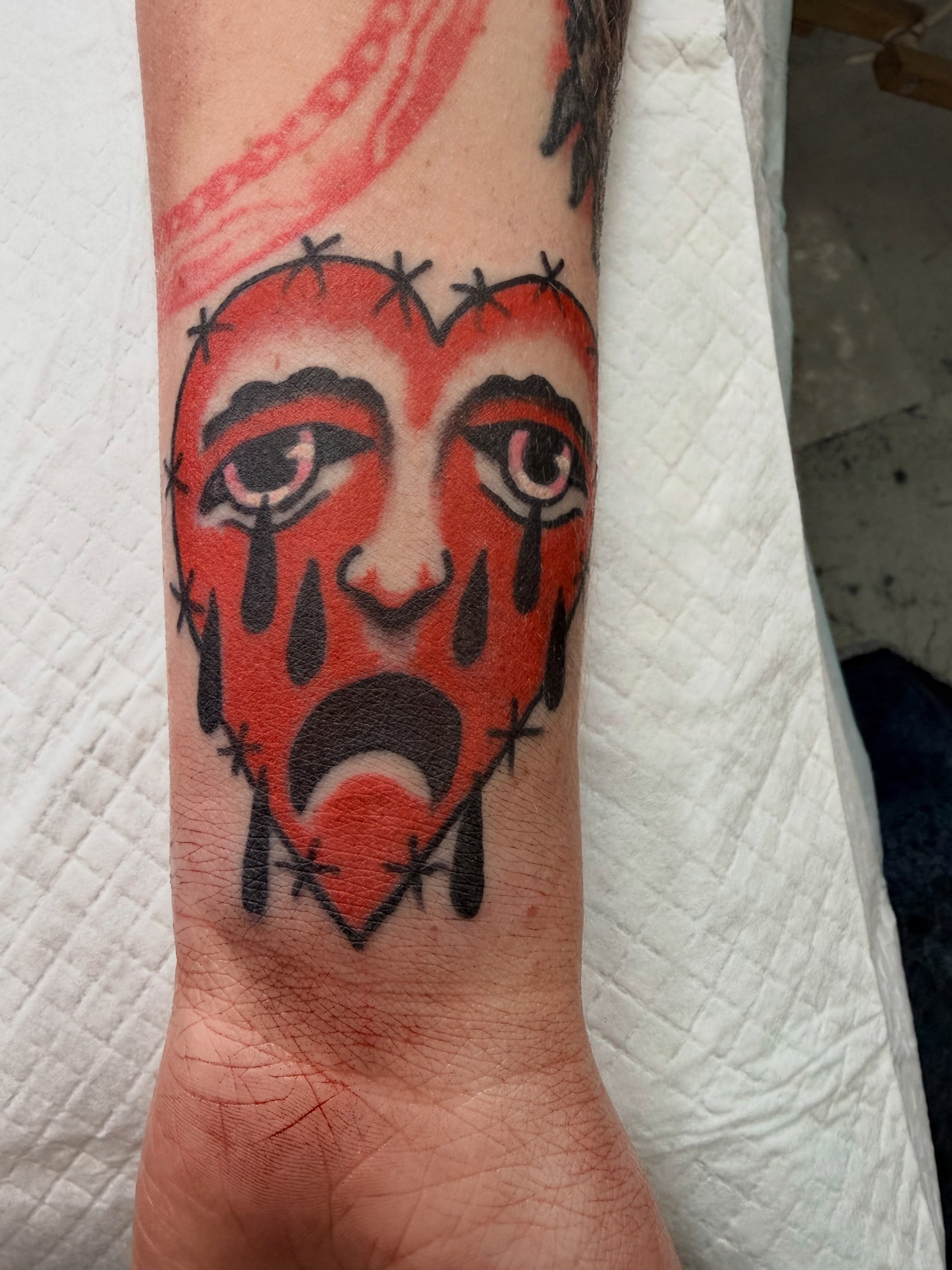 Crying face American traditional tattoo on the forearm by dave rash