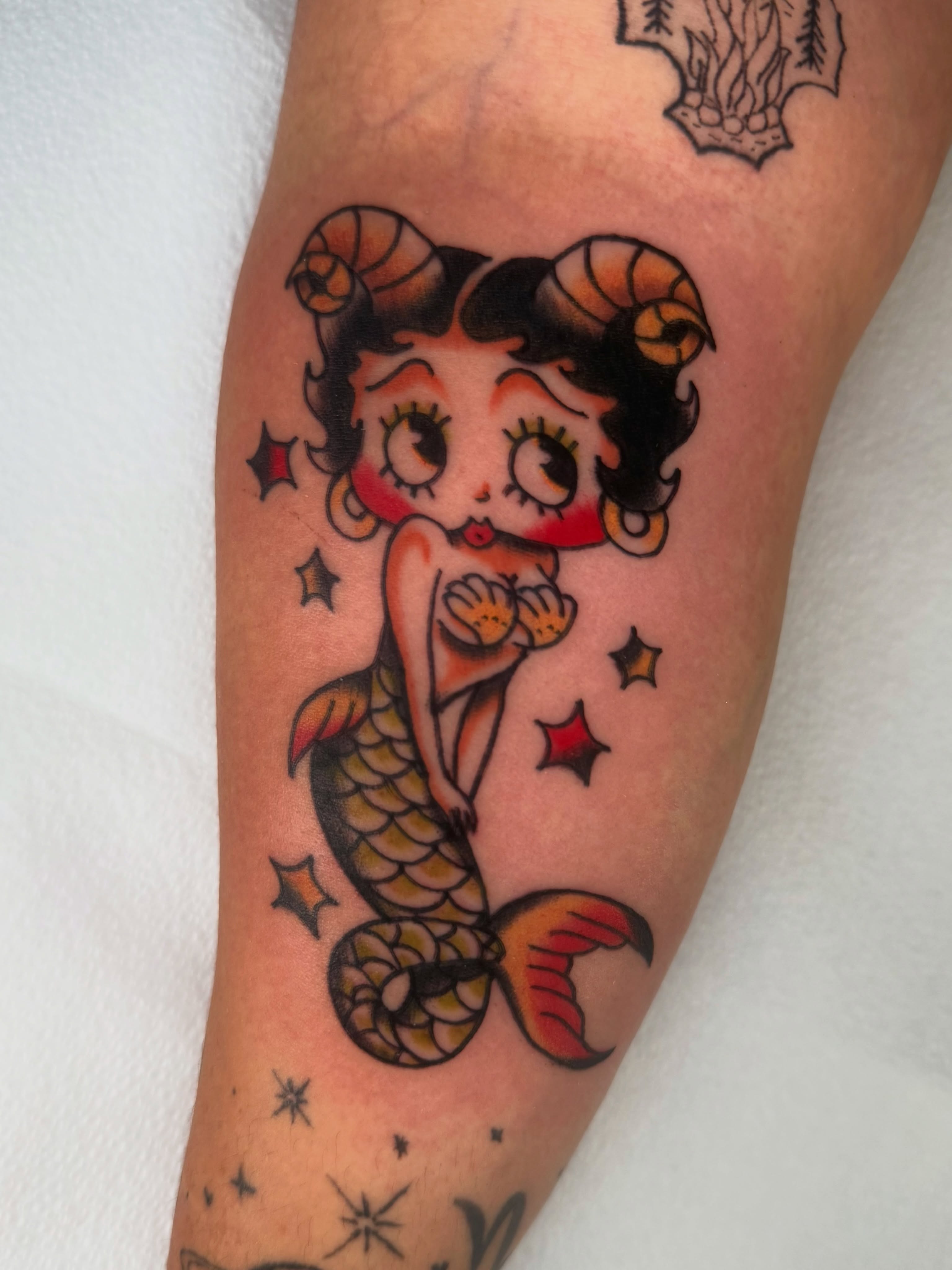 Betty Boop mermaid American traditional tattoo on the forearm by Lexie Graff