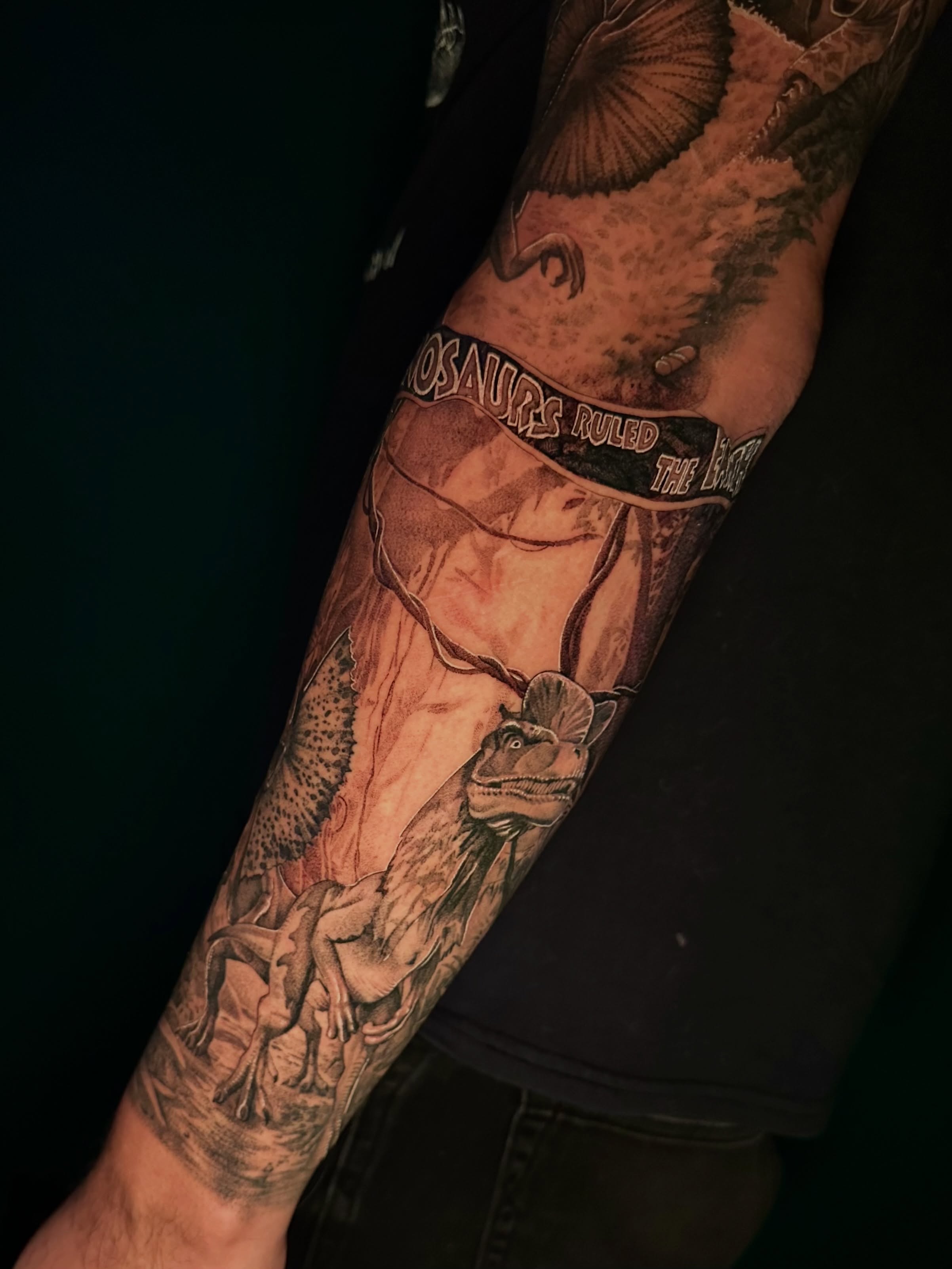 Dinosaurs realism tattoo on the forearm by Ghost
