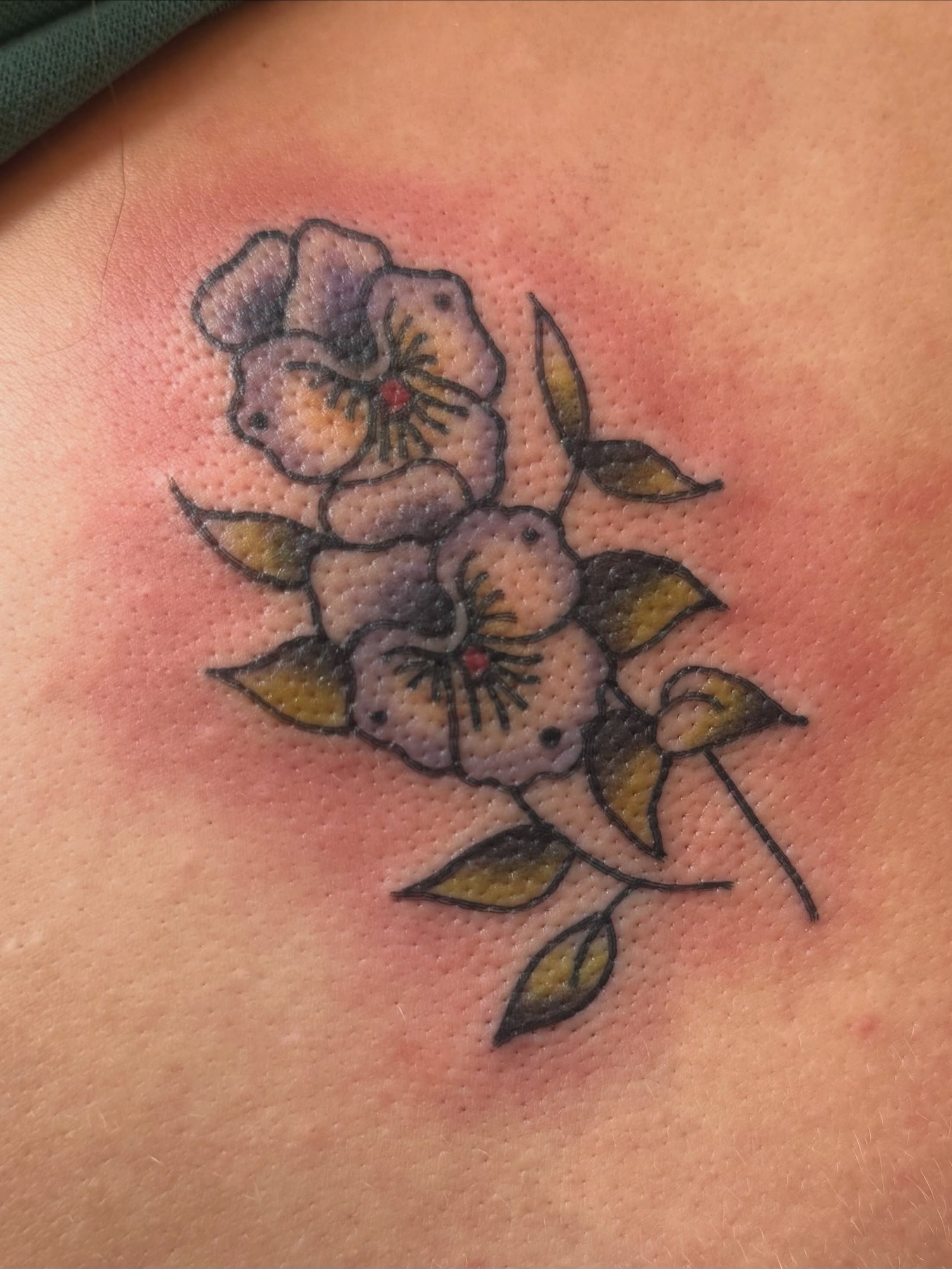 Flowers American traditional tattoo on the shoulder by Lexie Graff