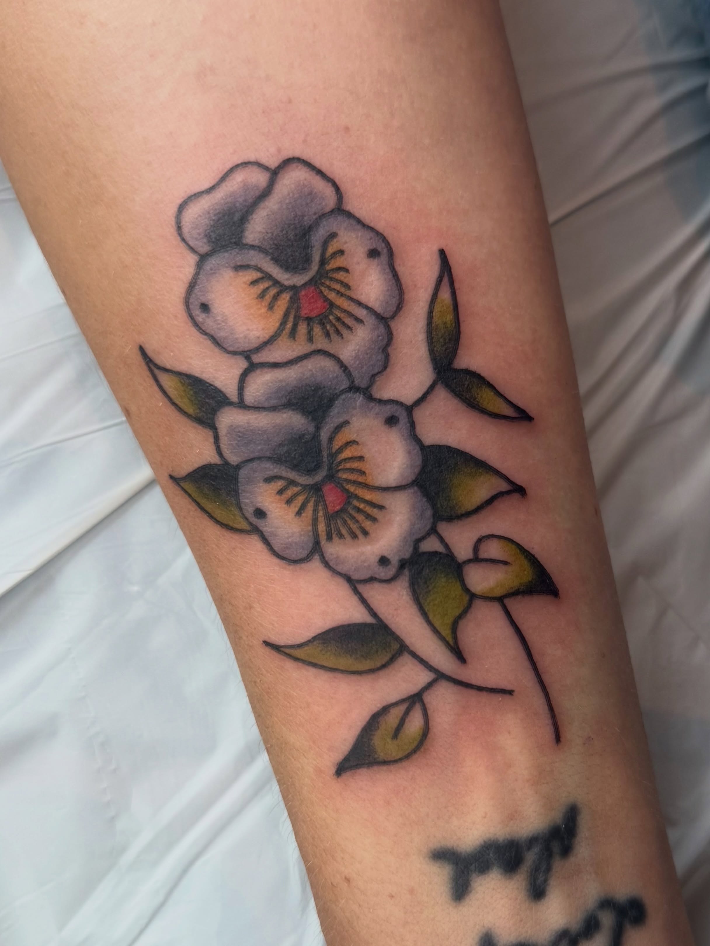 Flowers American traditional tattoo on the forearm by Lexie Graff