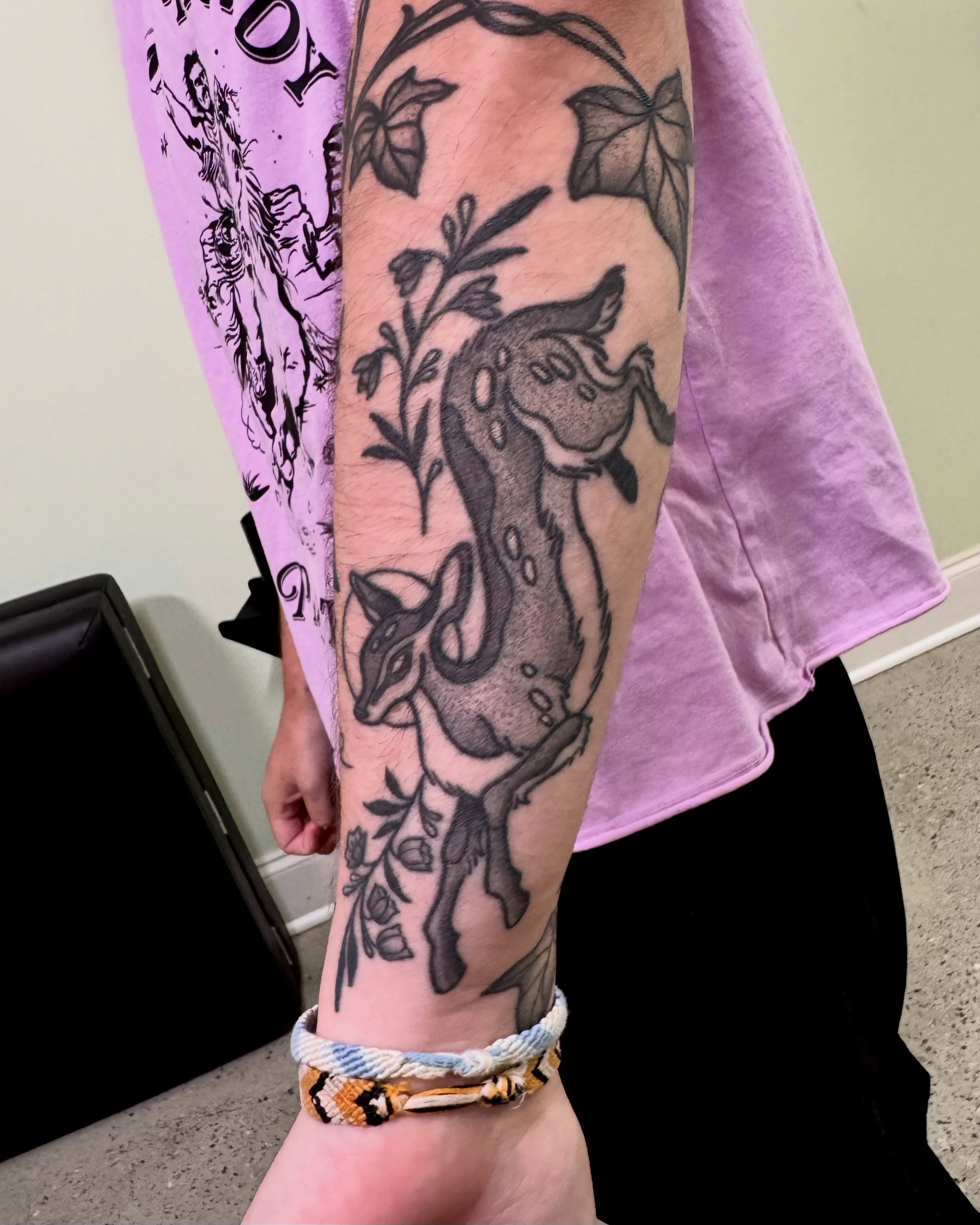 Goat and plant black and grey tattoo on the forearm by Eden Allen