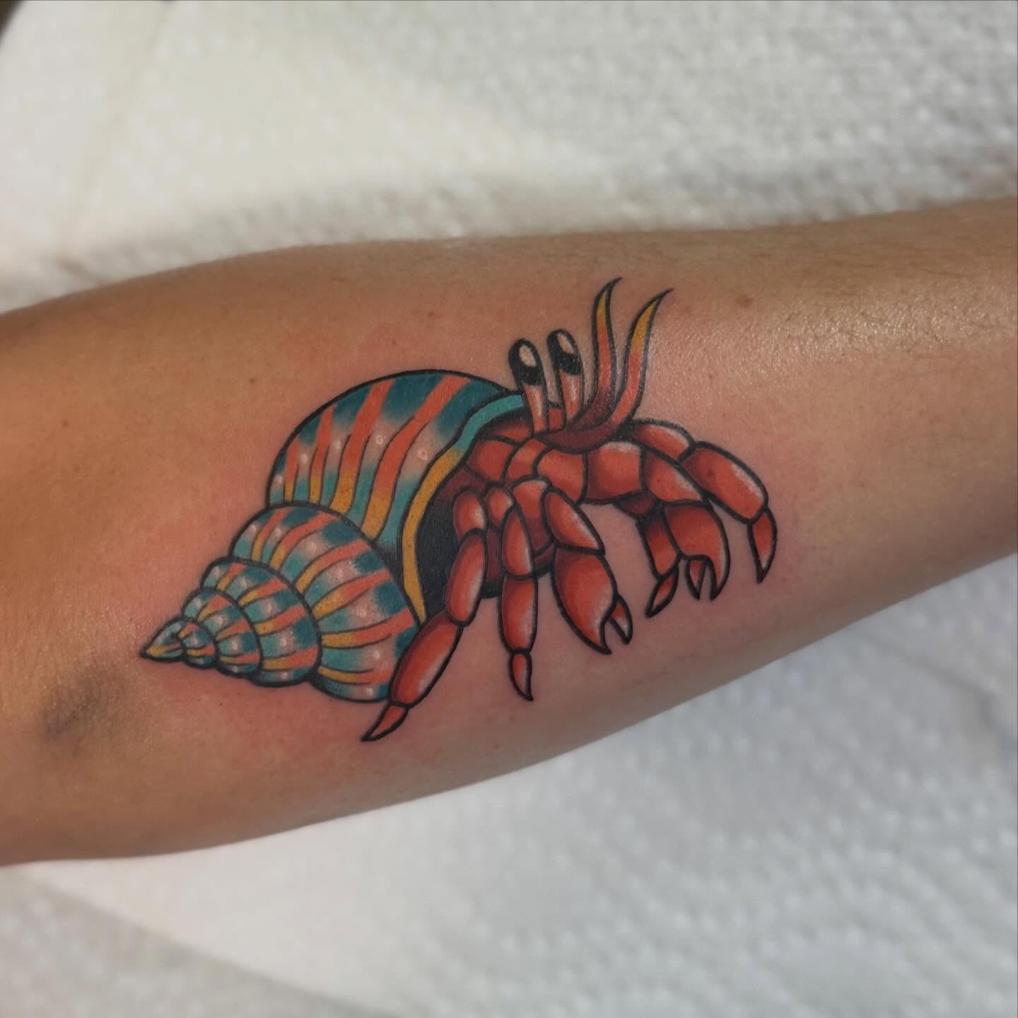 Hermit crab American traditional tattoo on the forearm by charlie
